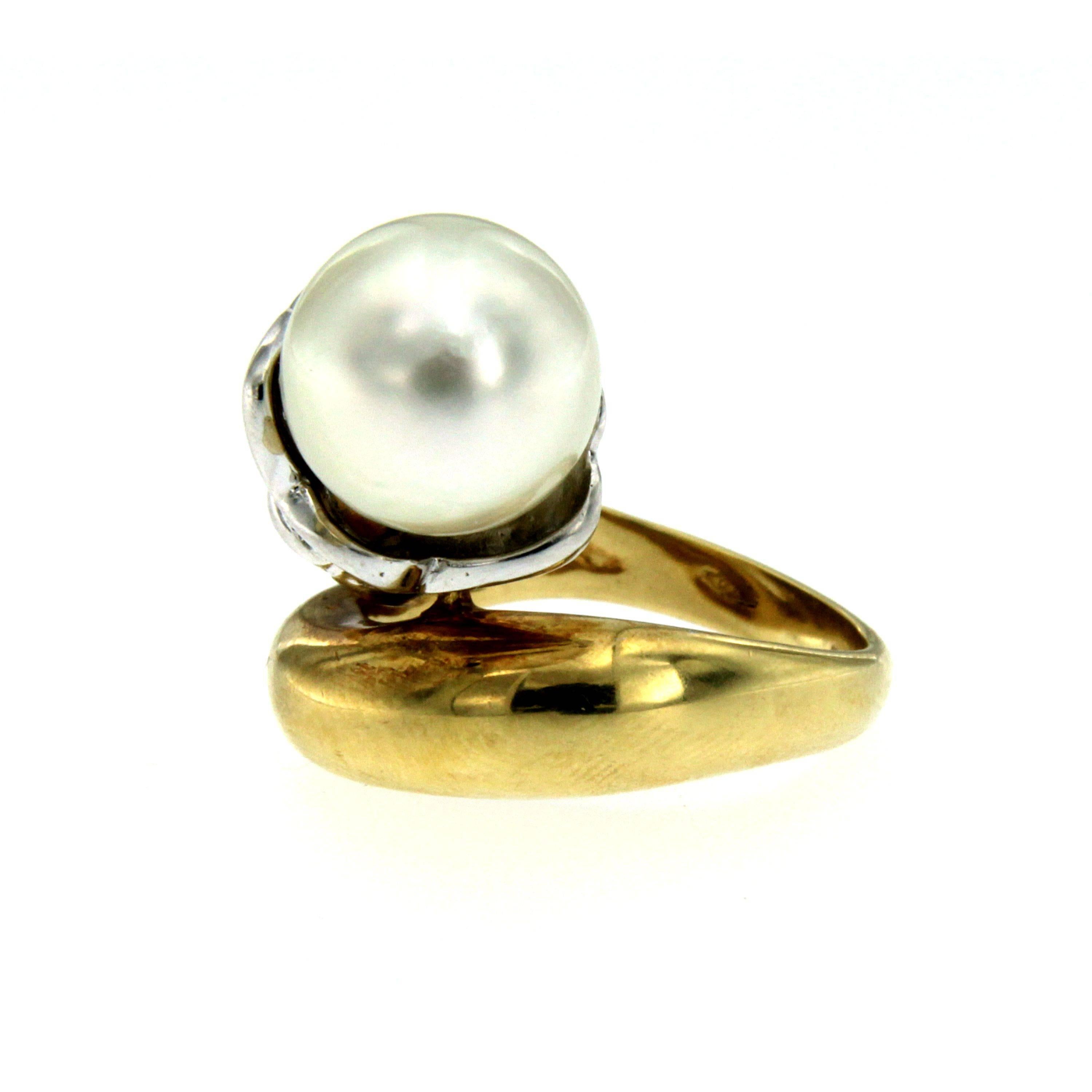 An original and unique cocktail retro ring set in 18K yellow and white gold hand worked into a gorgeous blooming flower. The ring features a center 11mm South Sea Pearl framed by .40ct of round brilliant cut diamonds.
This beautiful ring dates to