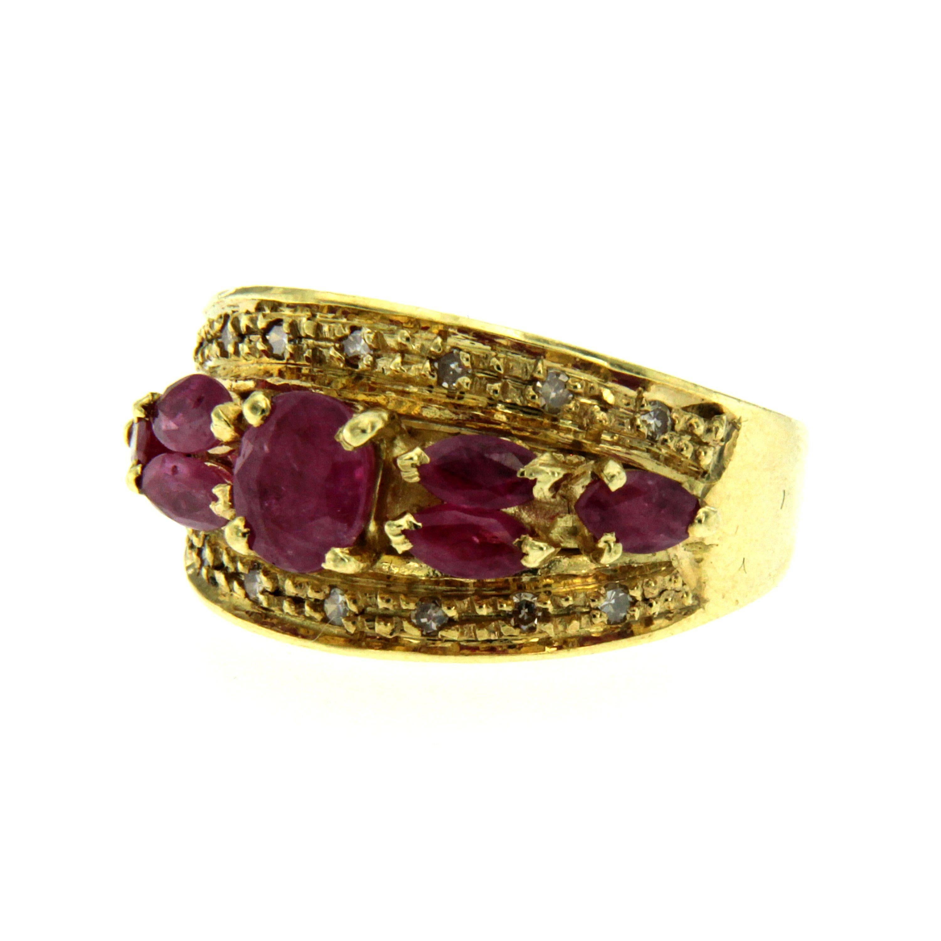 Gorgeous Retro ring handcrafted in 18k yellow gold set with 7 oval and marquise cut rubies weighing 1.00 carats accented by 14 small round brilliant cut diamonds 0.10 total carats. Circa 1950

CONDITION: Pre-owned - Excellent
METAL: 18k Gold
GEM
