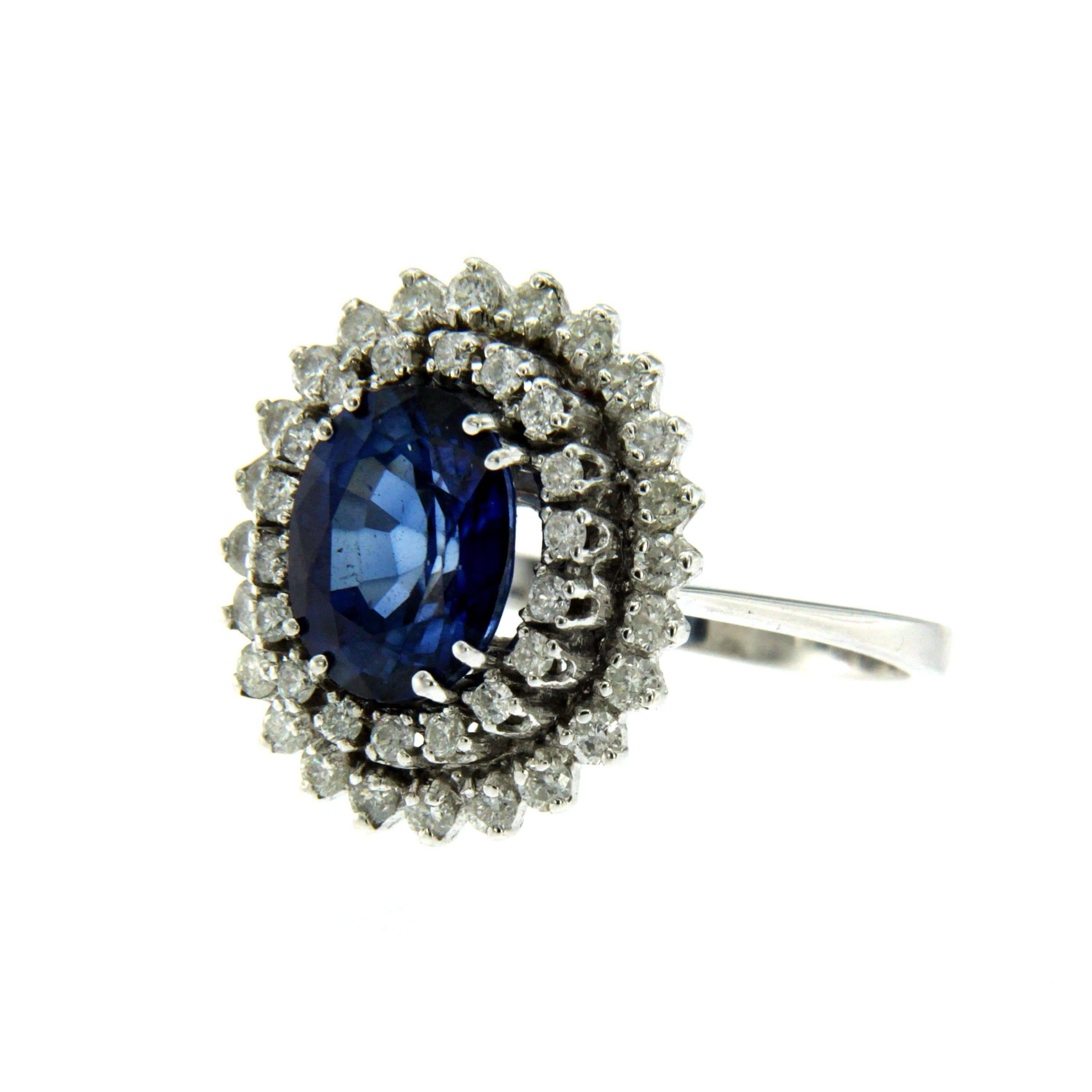 A fine and impressive 18k white Gold, Sapphire and Diamond Ring, set in the center with an oval-cut Sapphire weighing 3 carats framed by a double halo consisting of 1 carat of round brilliant cut diamonds graded G color and Vvs clarity.
Circa