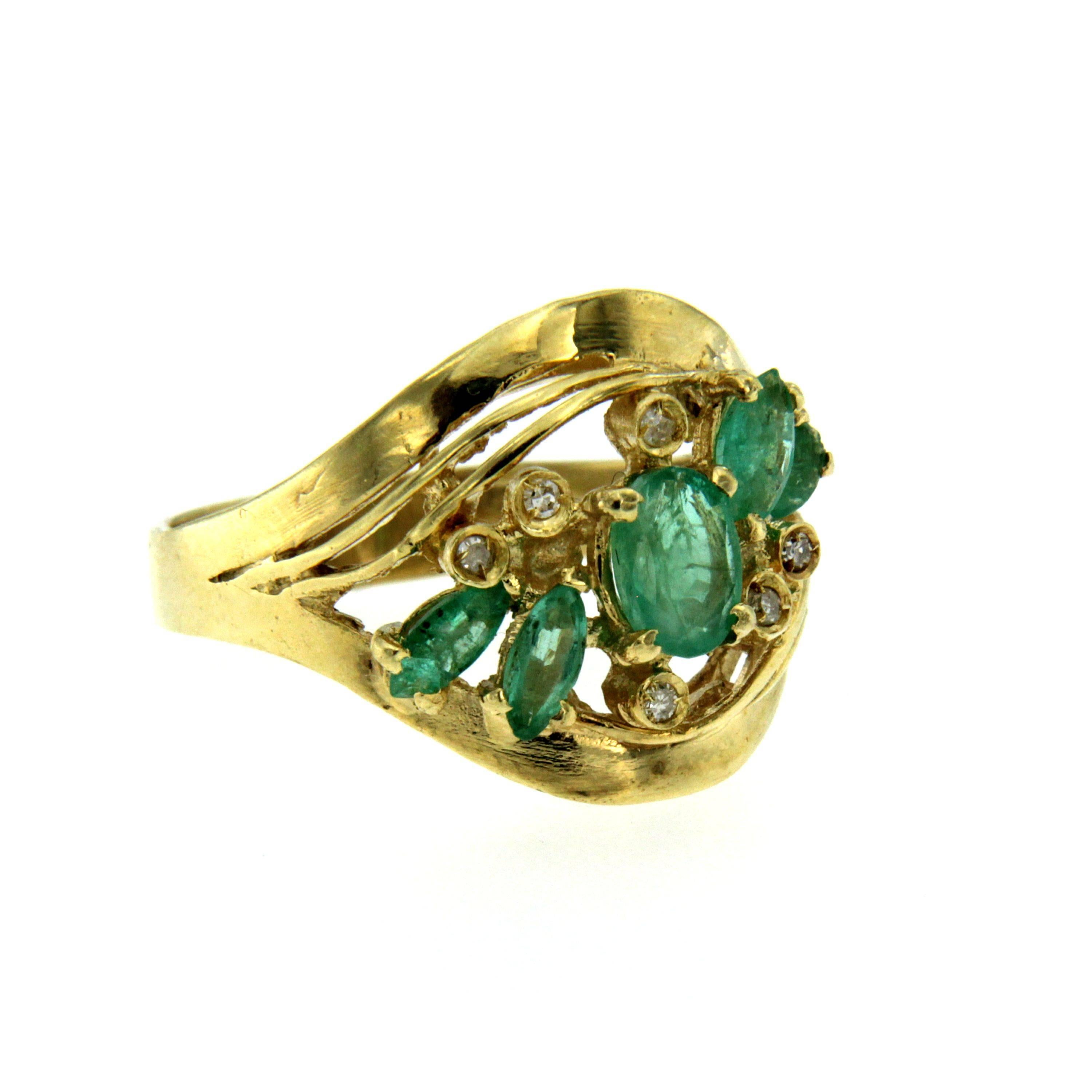 Gorgeous Retro ring handcrafted in 18k yellow gold set with 5 oval and marquise cut emerald weighing 1.00 carats accented by 6 small round brilliant cut diamonds 0.06 total carats. Circa 1950

CONDITION: Pre-owned - Excellent
METAL: 18k Gold
GEM