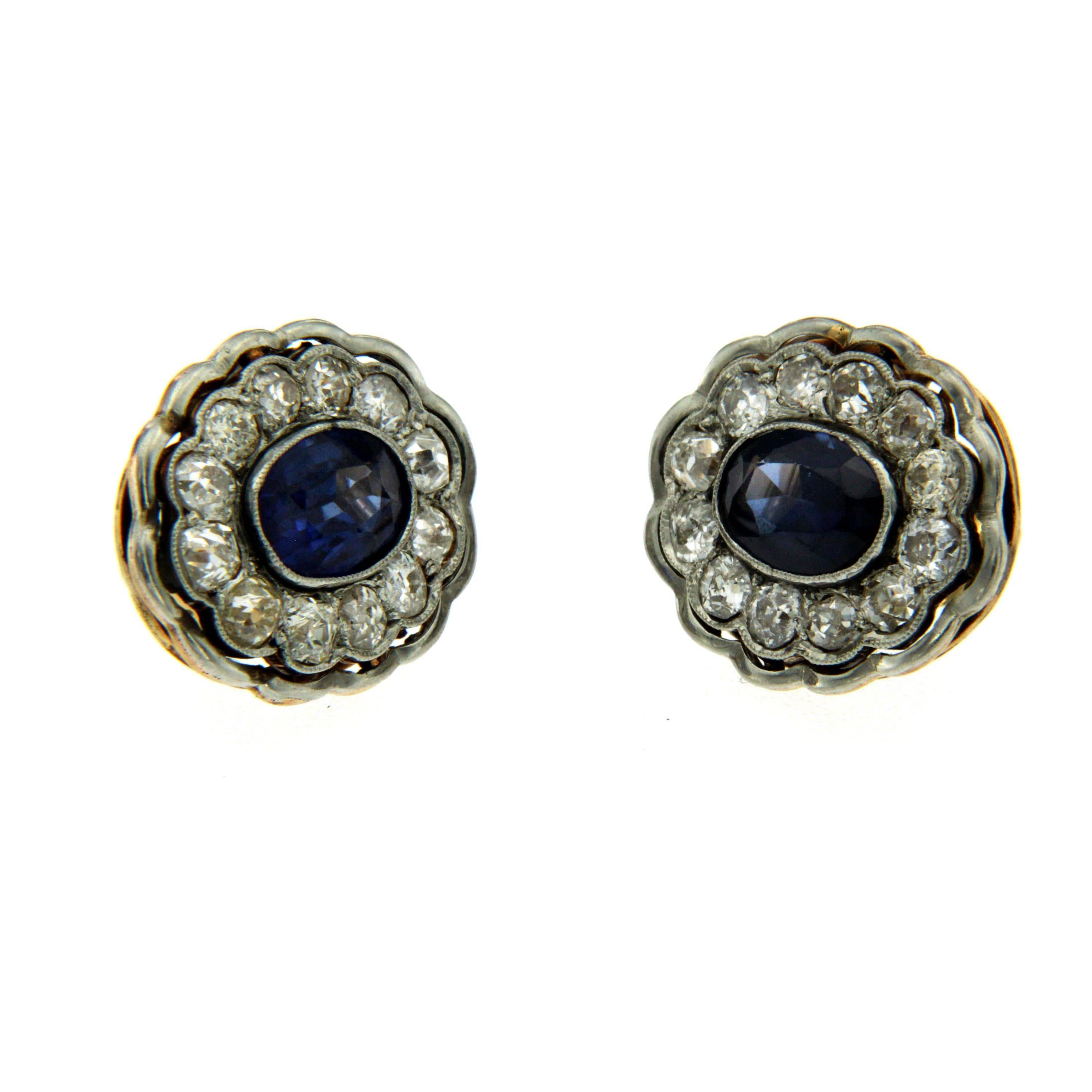 Victorian 18 karat gold synthetic sapphire and diamond earrings. These gorgeous sapphire and diamond clusters feature 2 center synthetic sapphires that are approximately 2.00 carats each along with an approximate total diamond weight of 3.00 carats