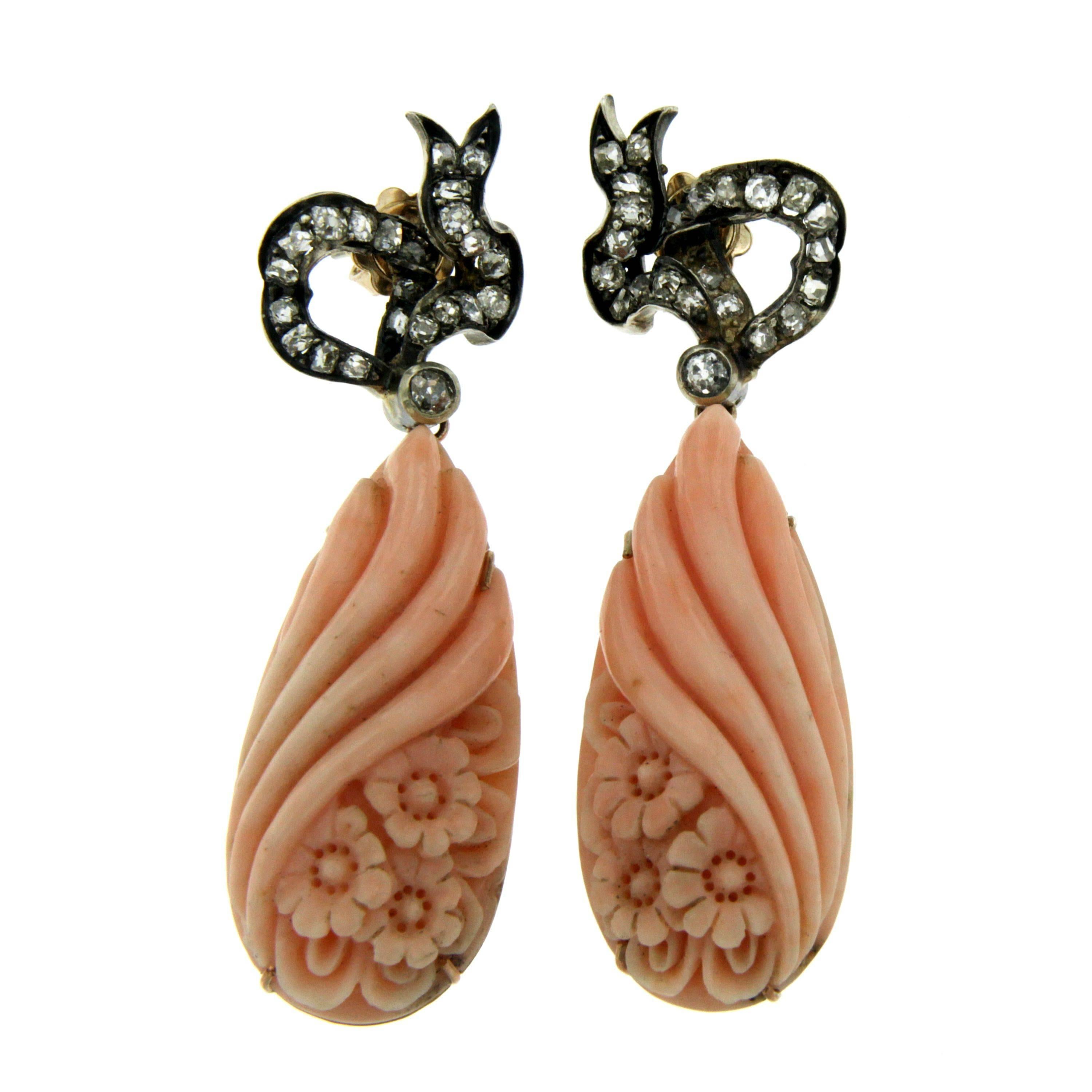 Elegant pink coral and gold earrings. The pear shaped coral feature a beautiful workmanship which resembles a bouquet of roses accented by 1.80 cts of old cut diamonds. Circa 1890

CONDITION: Pre-owned - Excellent 
METAL: 12k Gold and Silver
STONE: