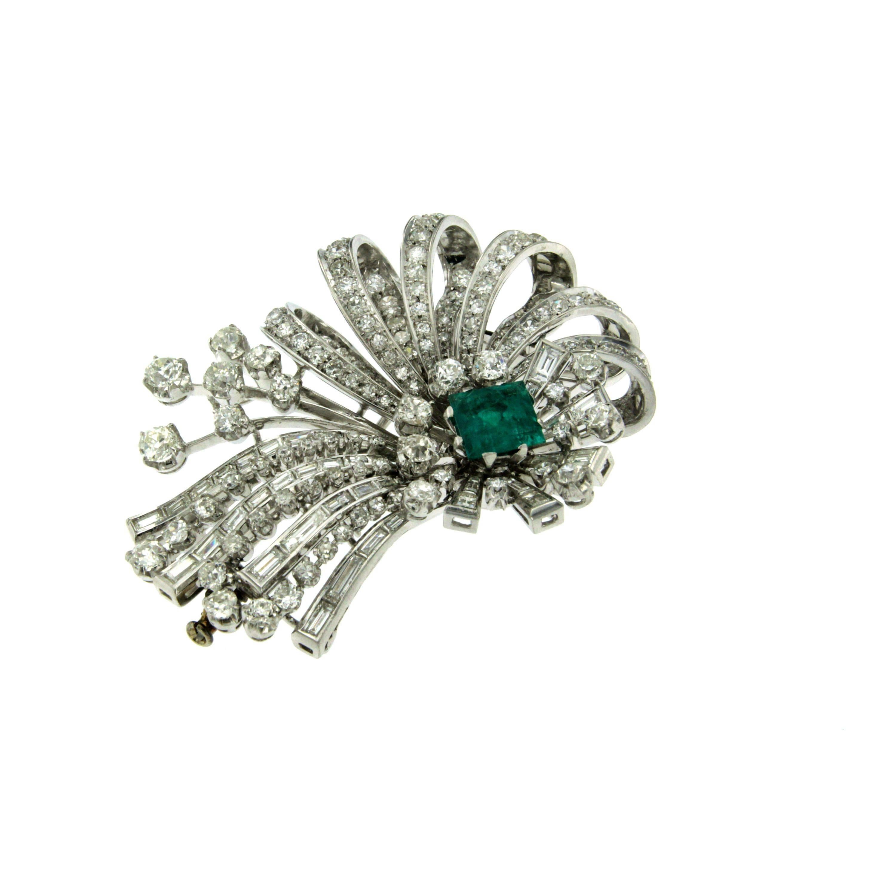 A fabulous Art Deco flower brooch set with a Colombian Emerald weighing approx. 3.50ct and round/baguette cut diamonds weighing approx.10.00 total carats. 
Handmade Platinum mounting; 
This piece is designed and crafted entirely by hand in the