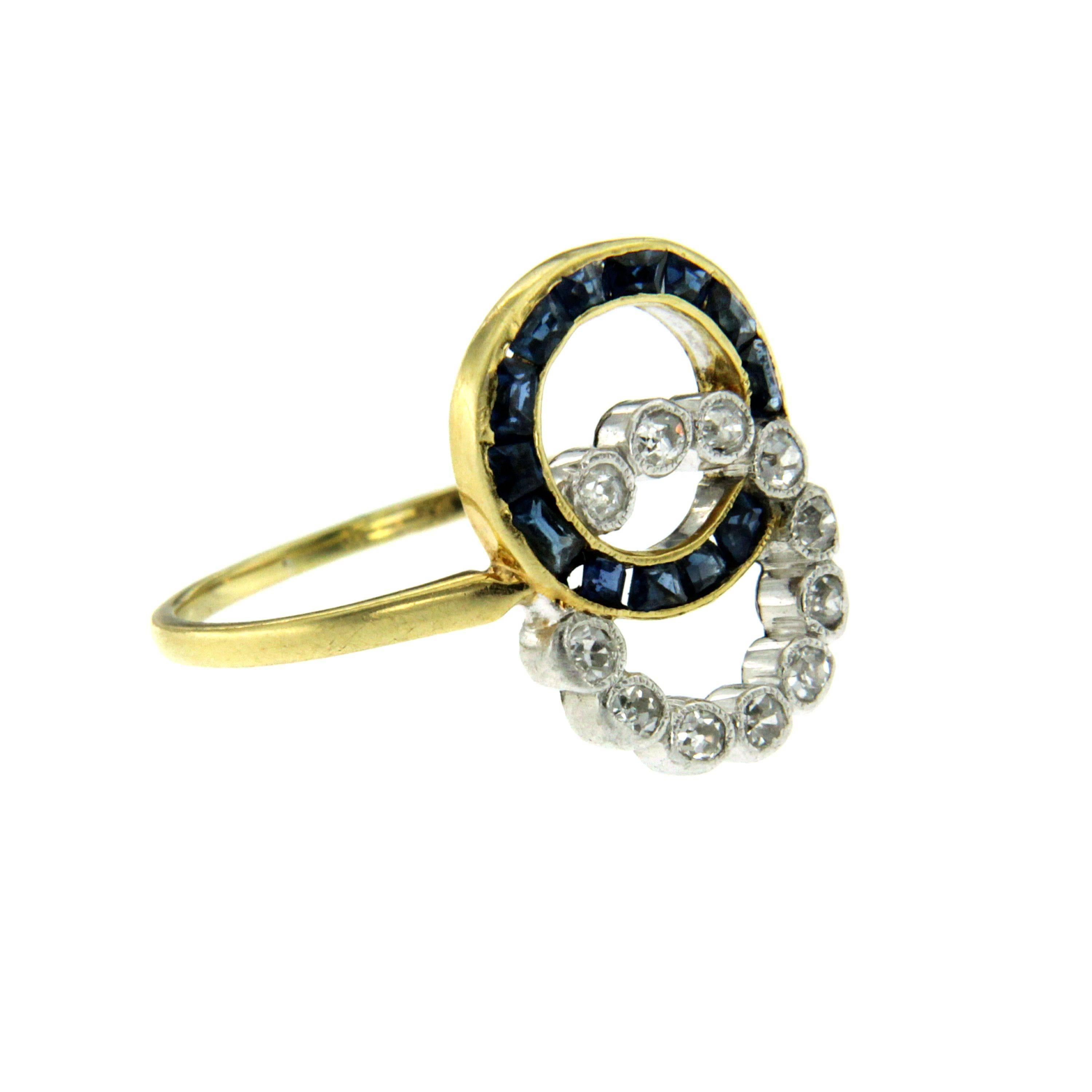 A gorgeous Art Deco 18k yellow gold double hoop ring set with custom cut sapphires weighing approx. 0.50 ct. and old mine cut diamonds weighing 0.25ct. G color VVS. Circa 1930

CONDITION: Pre-owned - Excellent 
METAL: 18k White Gold 
GEM STONE: