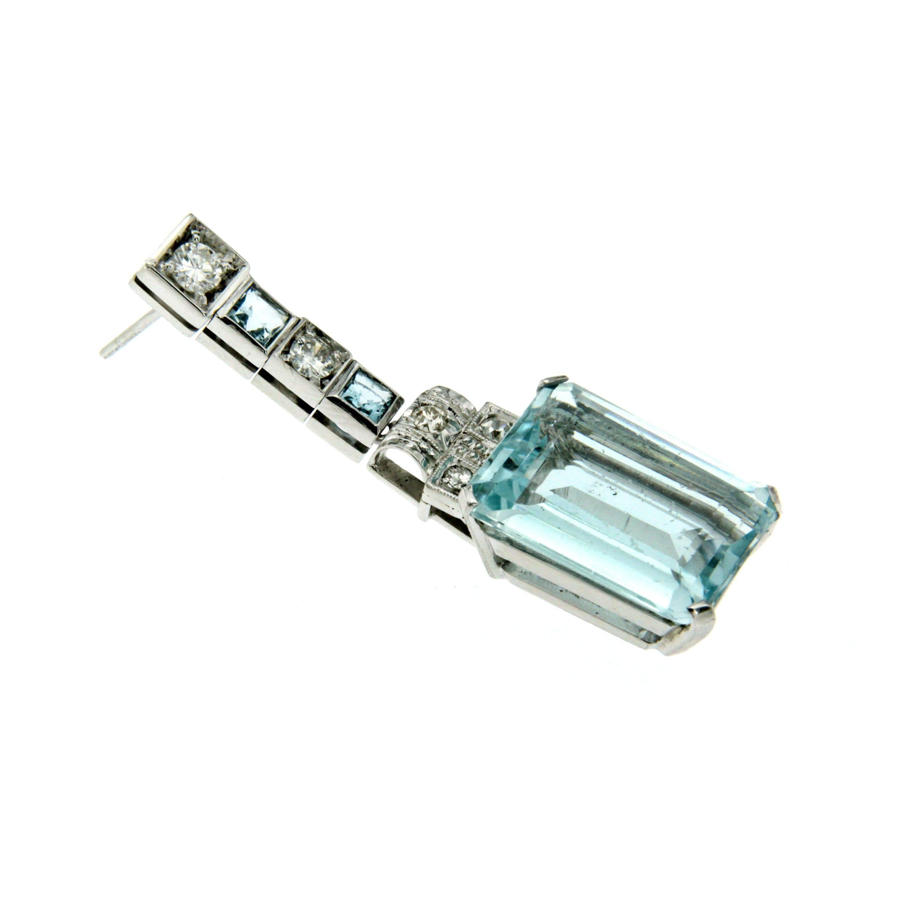 This fabulous Art Deco pair of earrings are set in 18k white Gold and features two beautiful emerald cut Aquamarine weighing a total of approximately 18.14 cts surrounded by round brilliant cut diamonds weighing 0.70 G color Vs and square cut