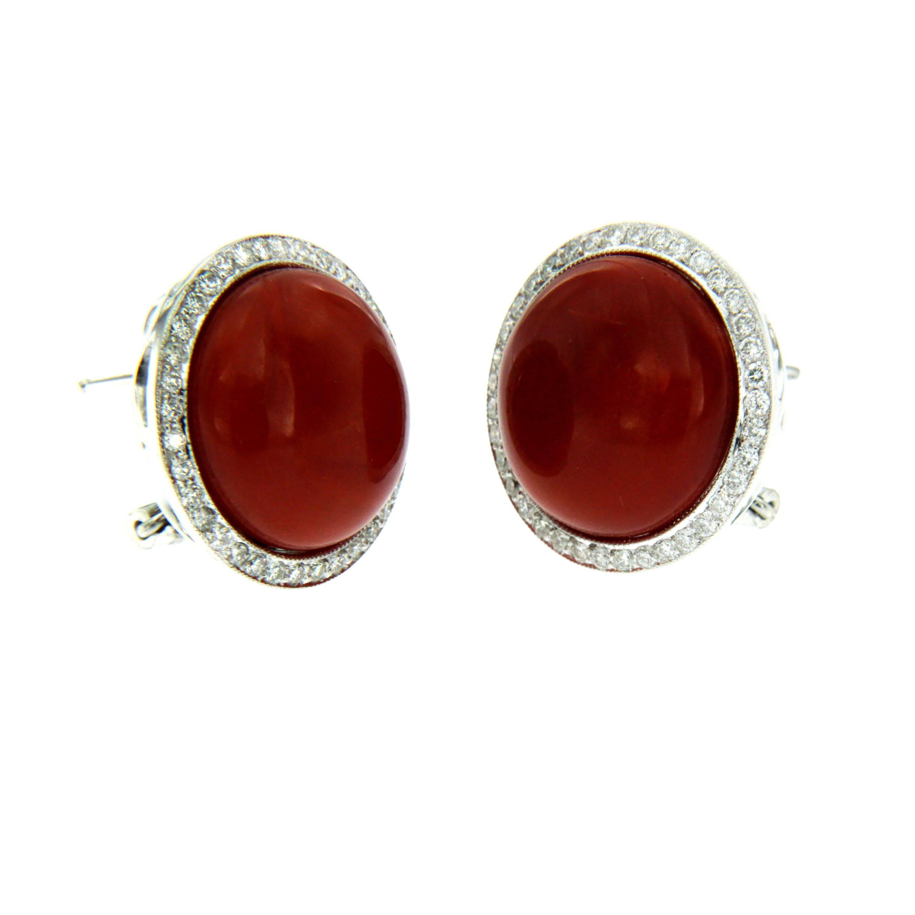 Truly exclusive earrings out from 1990s, hand crafted of solid 18Kt white gold. 
The earrings are set with a Natural Aka Coral (Japanese) of the greatest variety, surrounded by 0.60 total carat of sparkling round brilliant Diamonds graded G color, 