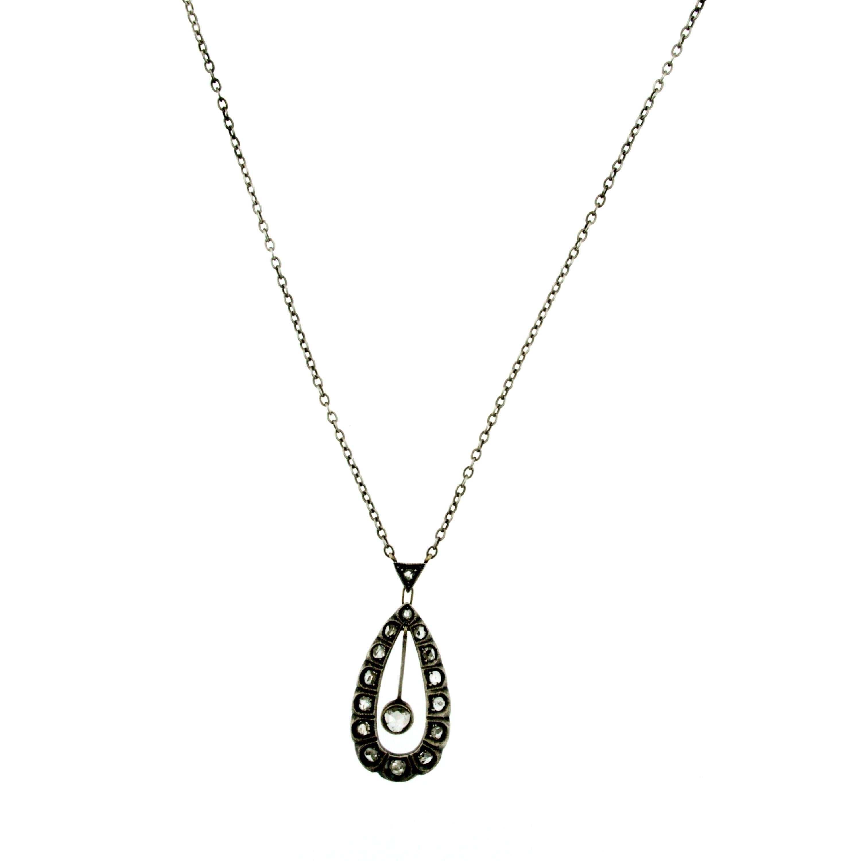 A fascinating Victorian period diamond pendant necklace crafted in 12k white Gold and Silver. 
Beautifully hand crafted, this pendant features a central diamond encircled by rose cut diamonds for a total weight of approx 0.60 carats. 
Circa