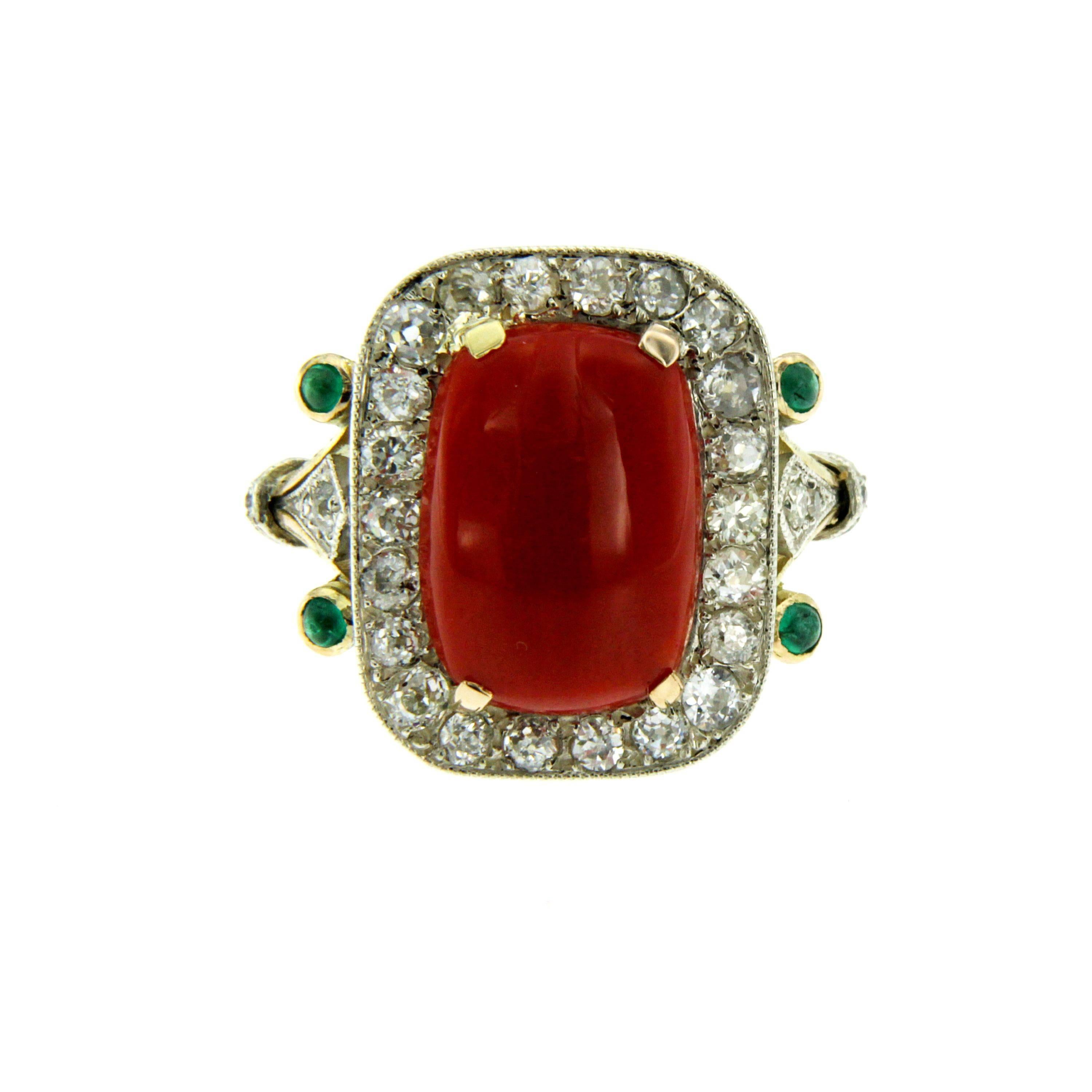 Beautiful Retro Cocktail Ring mounted in 18k white and yellow gold set with a  natural Sardinia Coral  14.56 x 10.56 mm and surrounded by approx. 1.50 carat of old cut diamonds graded G-H color Vvs and 0.15 cts of cabochon emeralds.

CONDITION: