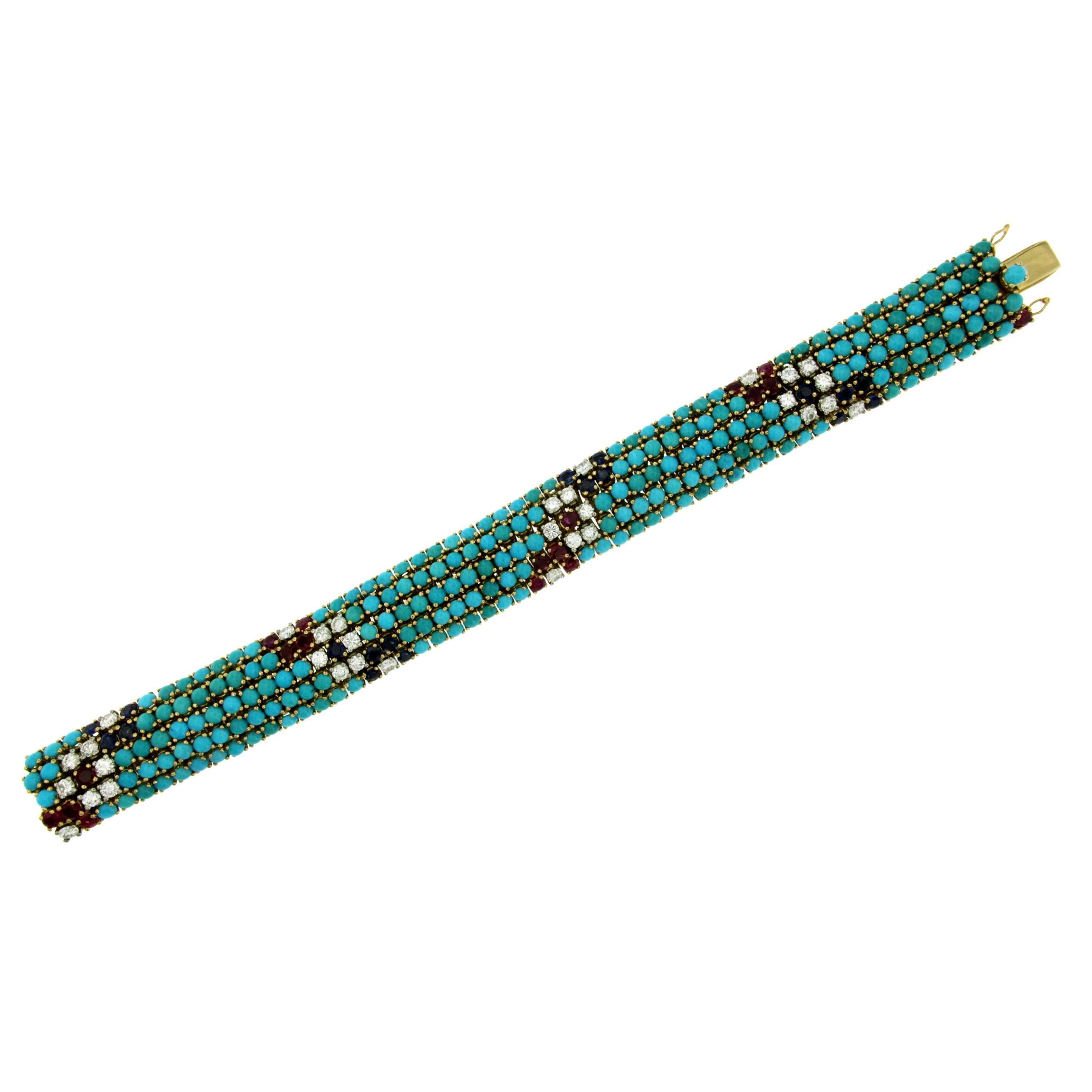 Made of 18k yellow gold this unusual vintage bracelet is set with natural turquoise cabochons, prong-set and mixed with natural sapphire, rubies and diamonds weighing 3.20 total carats G color Vvs clarity.
It is extremely flexible. Finished with a