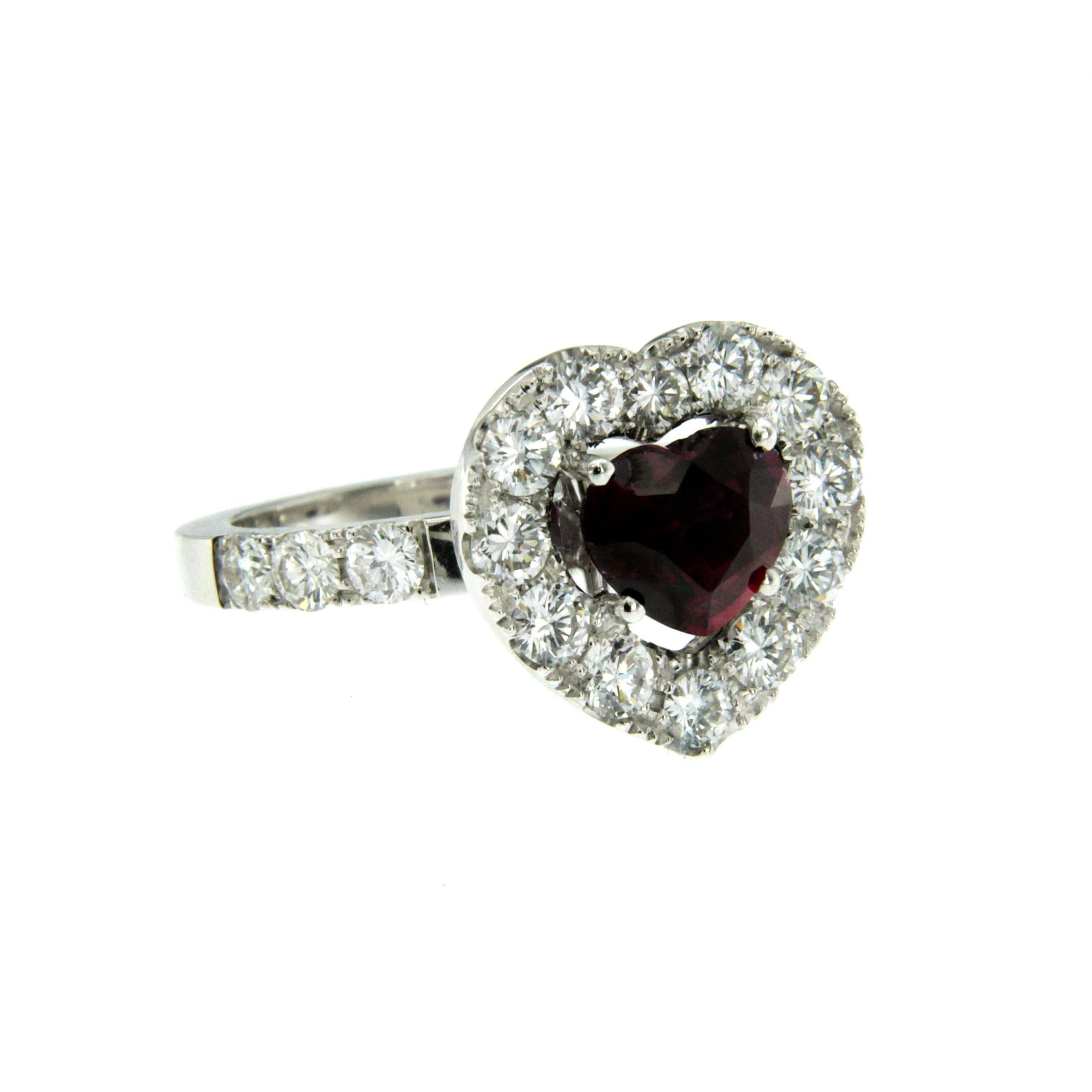 Beautiful 18k white gold ring set with a heart shaped ruby weighing 2.01 carats, flaked by round brilliant cut sparkling diamonds weighing 1.60 ct  F/G color VVS.

CONDITION: Brand New
METAL: 18k white Gold
GEM STONE: Ruby 2.01 ct - Diamond 1.60