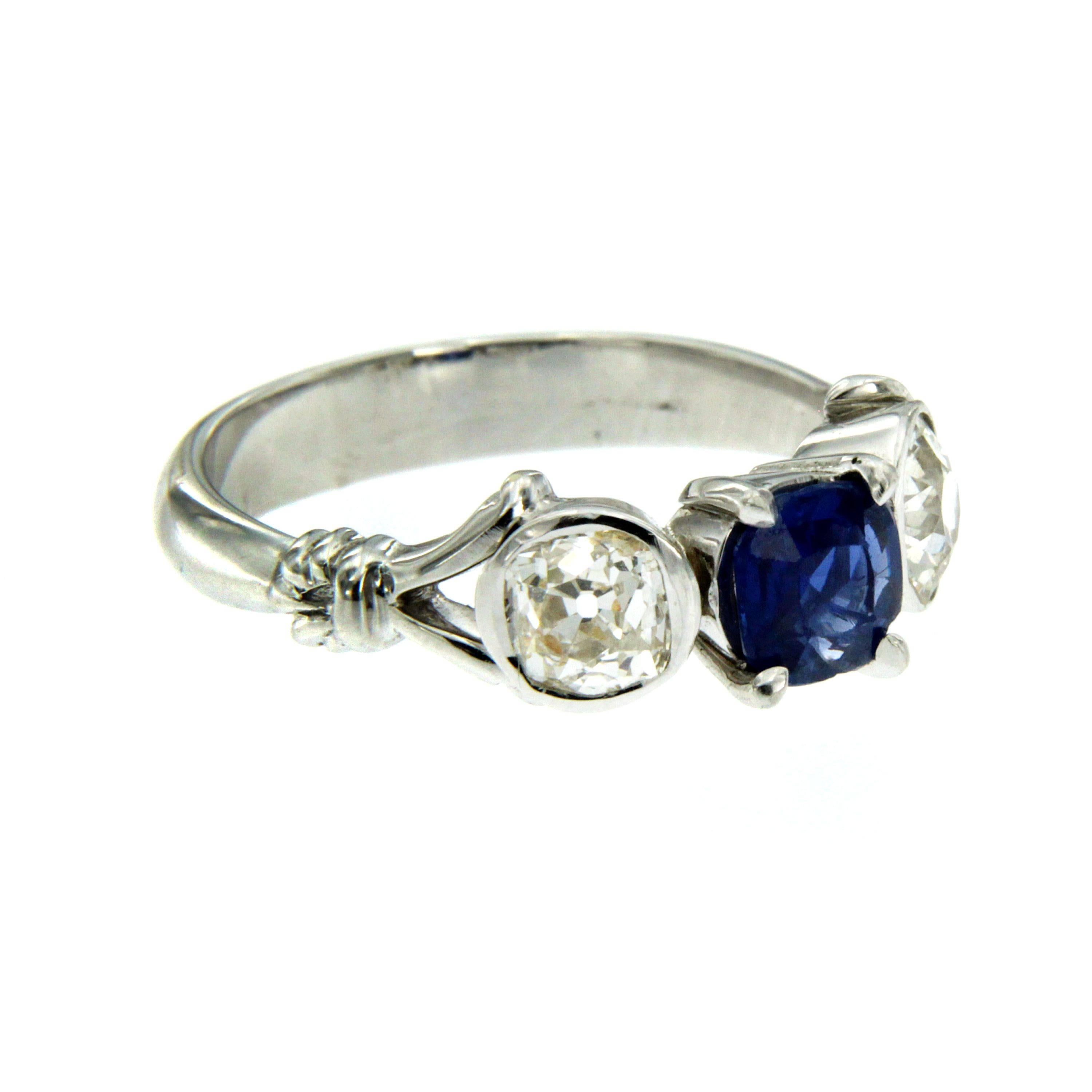 Classic three stone 18k Gold ring set with an oval cut  Ceylon Sapphire weighing approx. 0.90 carats and 2 old cut diamonds with a total weight of approx. 0.80 carats I color Vs clarity. The Sapphire is no heated.

CONDITION: Pre-Owned -