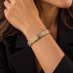 Bracciale rigido aperto Bulgari Parentesi in oro giallo 18 carati e acciaio inossidabile, 1980