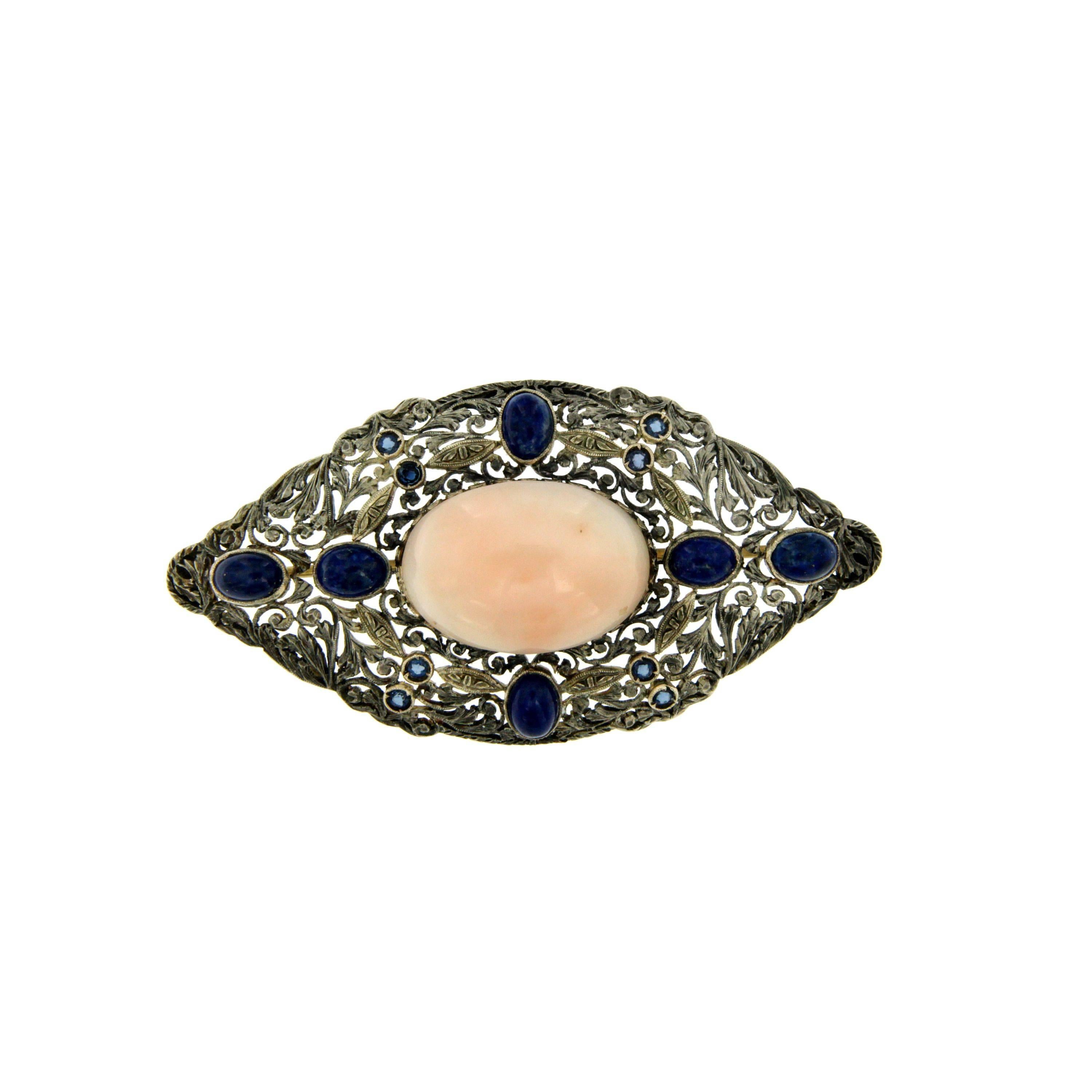 A Victorian brooch with a central light pink Coral flanked by Lapis Lazuli and small sapphires. Circa 1890

CONDITION: Pre-owned - Excellent 
METAL: 12k Gold and Silver
DESIGN ERA: Victorian - Circa 1890
WEIGHT: 12.30 grams
MEASURES: height 1.29 in