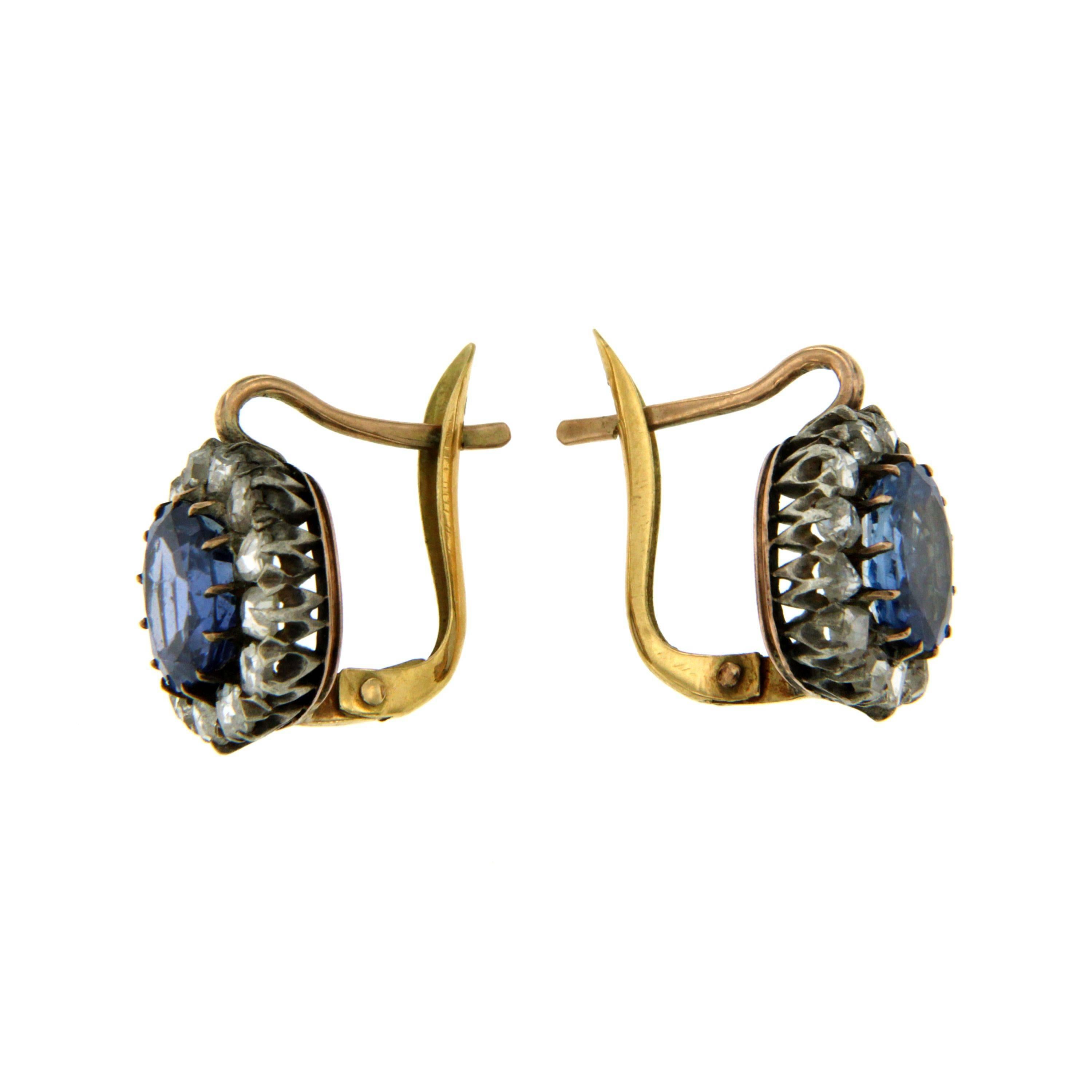 Victorian 12 kt gold and silver cluster earrings feauturing 2 center sapphires weighing approximately 5.47 total carats along with an approximate total diamond weight of 1.00 carats rose cut diamonds. Circa 1890.

CONDITION: Pre-owned - Excellent