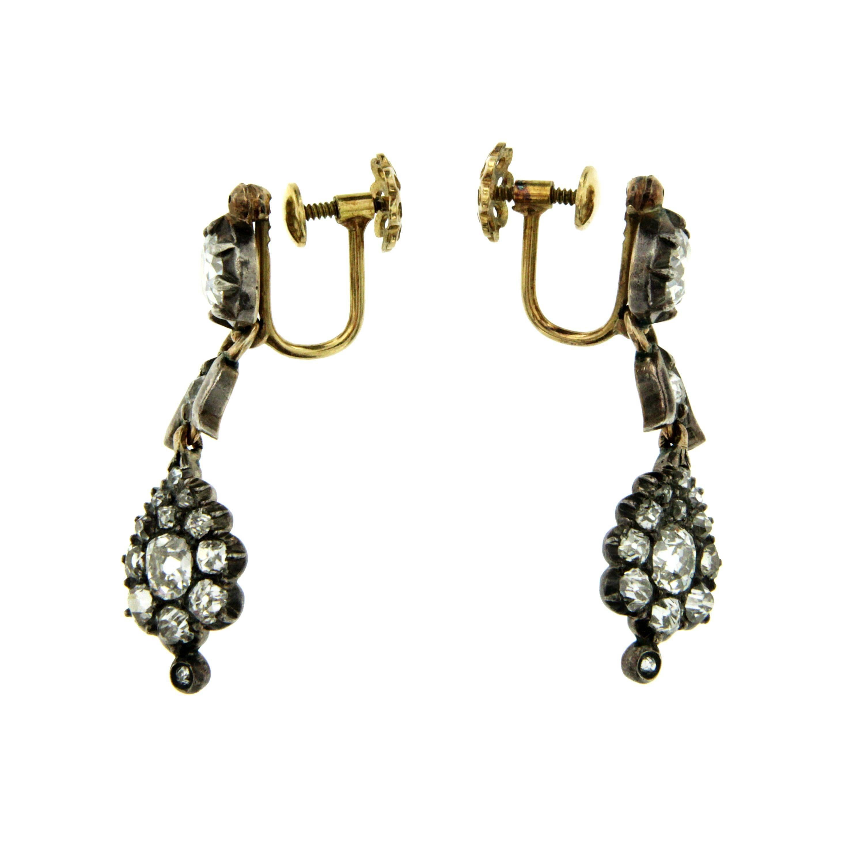 These Victorian earrings are set with 3.0 carat of sparkling old mine cut Diamonds H color,  approximately 1.29" in length (3.3 cm). Screw back closure.
Tested 12k yellow gold and silver, Entirely hand crafted English, circa 1890.

CONDITION: