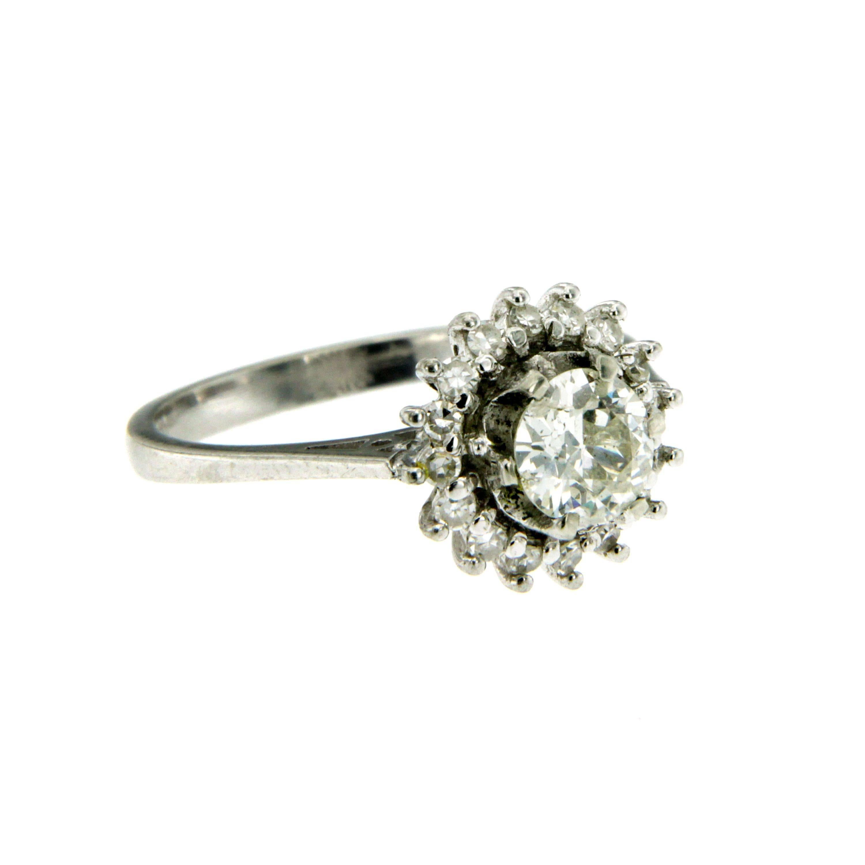 A beautiful 18k white Gold ring featuring a flower design set in the center with an old mine cut diamond weighing 1 ct H color VS clarity, framed by 0.15 carat of old cut diamonds.
Circa 1930

CONDITION: Pre-owned - Excellent
METAL: 18k Gold
GEM