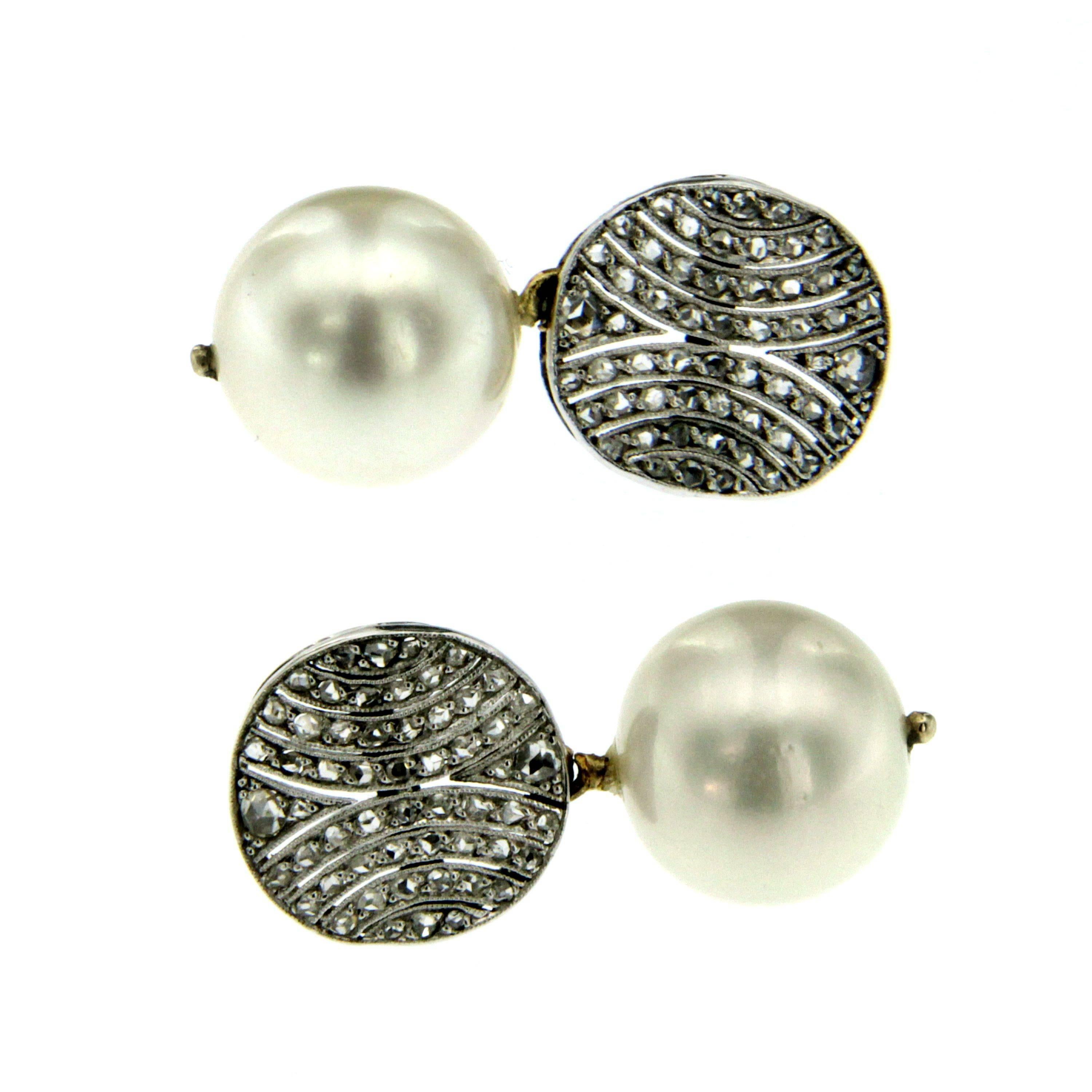 Vintage Earrings set with Diamonds and South Sea Pearls crafted in 18k white Gold, made circa 1980.
The pearls are suspended from 2 hemispheres set with european cut diamonds with a total weight of  0.90 carats.
Pearls measure 12.13 mm