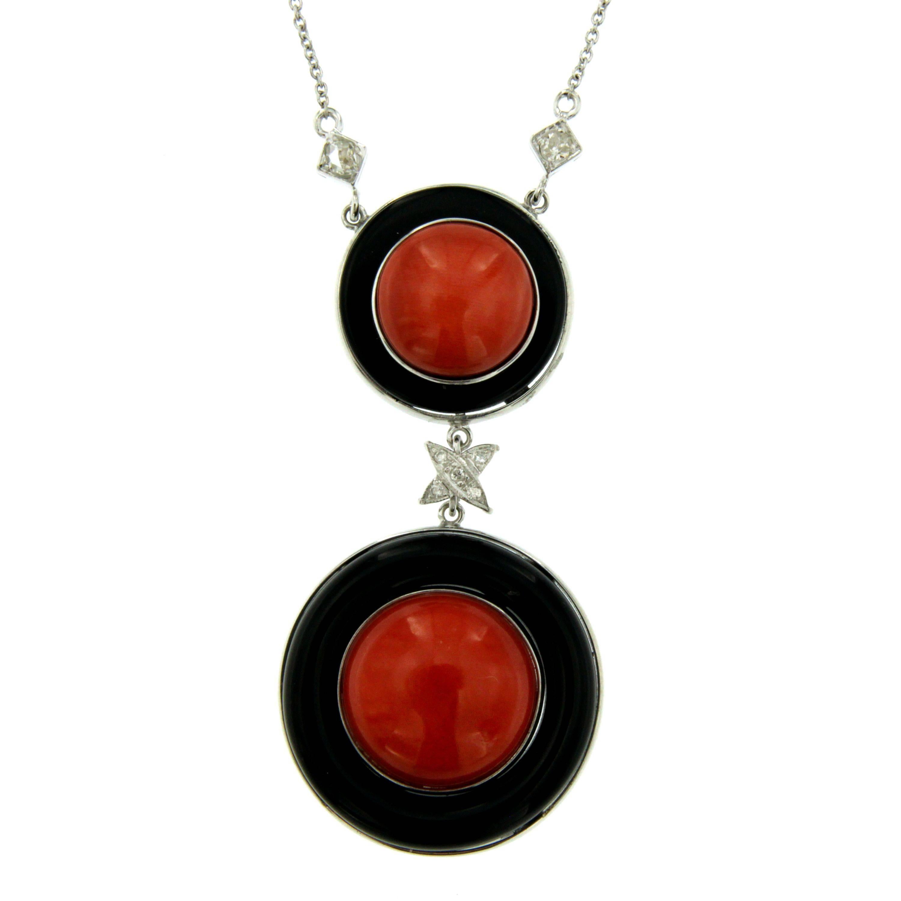 This stylish Sardinian Coral, Onyx and Diamond Vintage pendant is set in 18 karat gold.  The pendant is suspended by a 17 inches in lenght gold chain but can be shortened or lengthened as needed.
Total diamond weight: 0.25 carats
Circa