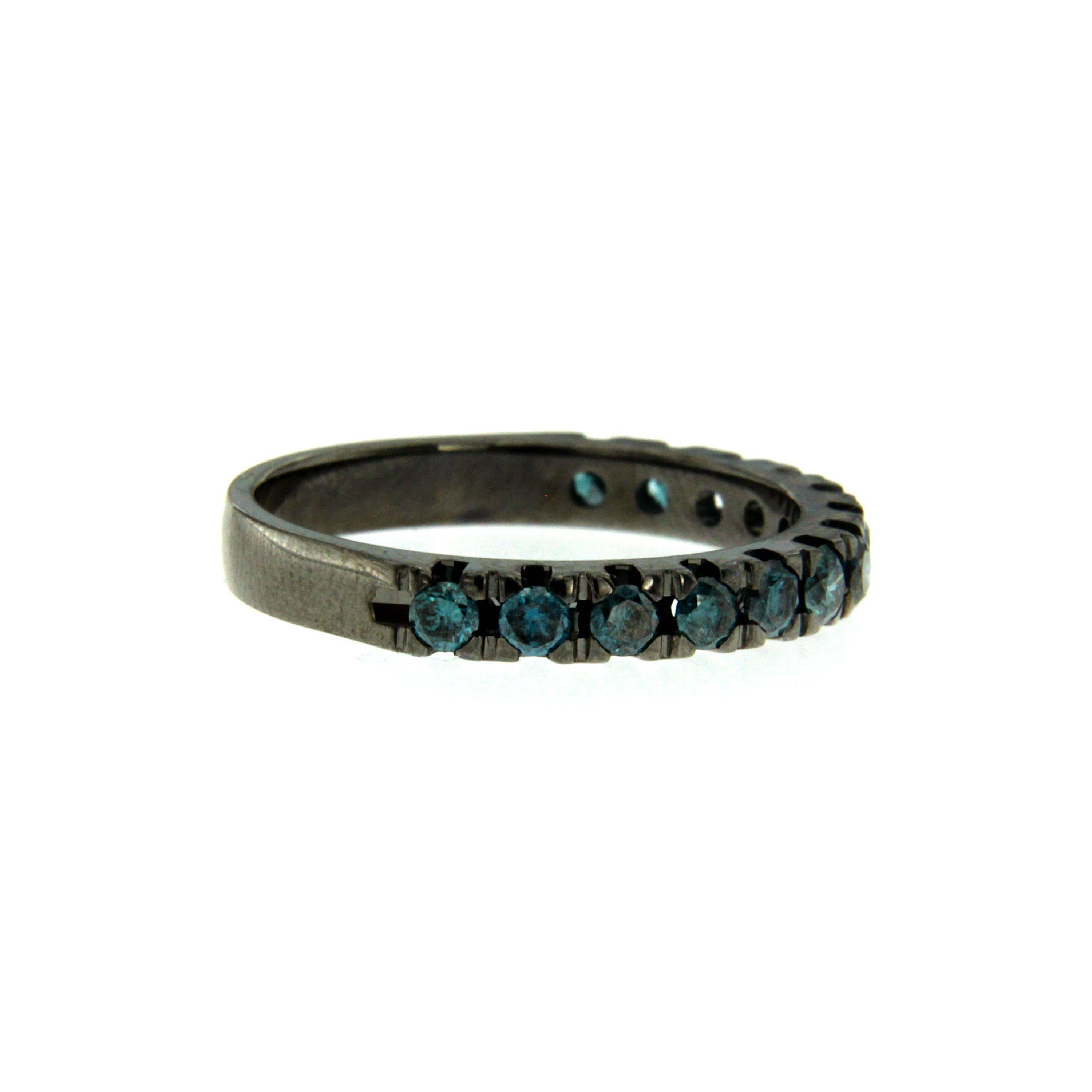Crafted from 18k black gold this contemporary ring is decorated with a continuous line of 0.70 cts colored blue diamonds along the band. Wear yours alone or stacked with similar styles.

CONDITION: Brand New
METAL: 18k black Gold
GEM STONE: Colored