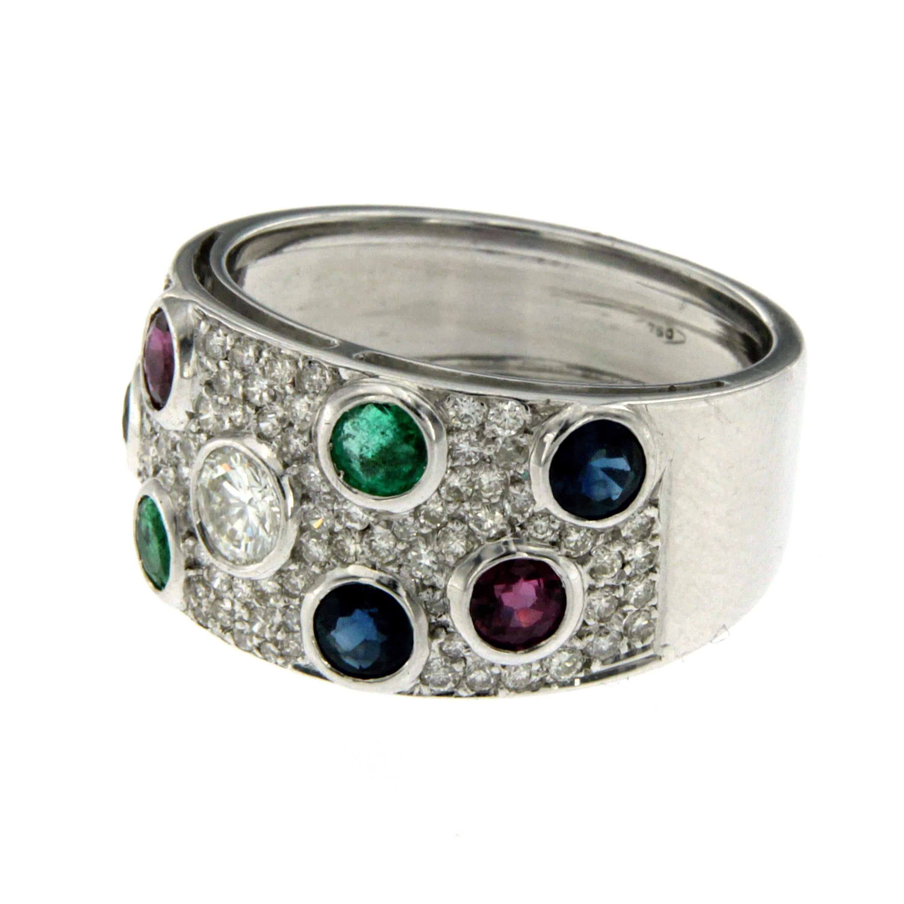 This Multi-Stone ring is set with a central Diamond weighing .80 ct, 0.30 ct of pavè diamonds, 1 ct of natural Sapphires, 0.80 ct of  natural Rubies and 0.80 ct of  natural Emeralds. 
A unique hand made ring. Made in 18K white gold.
An excellent