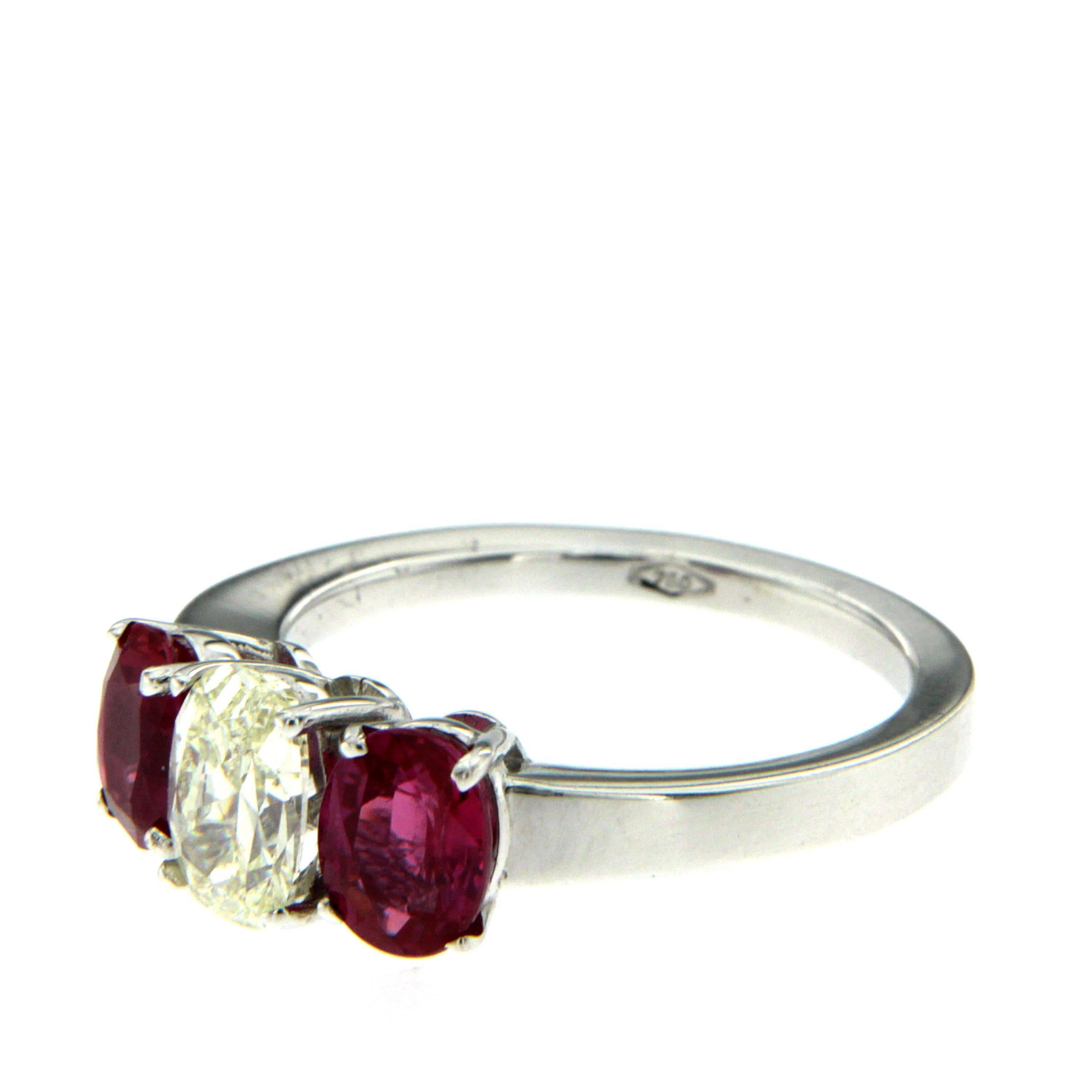 18k white Gold three stone ring containing one oval cut Diamond weighing 1.00 carat graded L color VVS2 clarity. The diamond is flanked by two oval shape mixed cut Rubies weighing 0.86 and 1.12 carats
Both rubies comes with an American Gemological