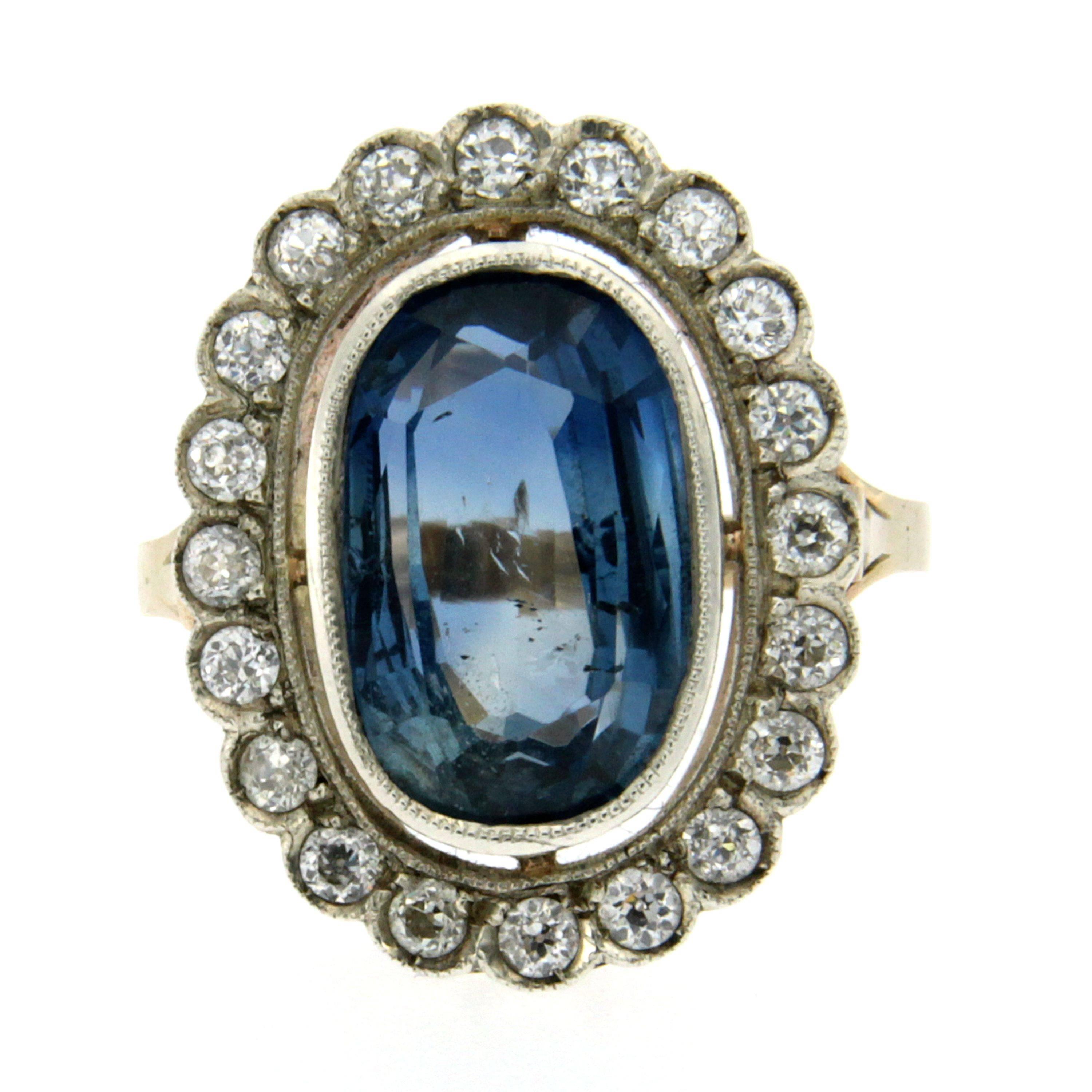 A classic Victorian piece from 1890s that features in the middle a wonderful and very large natural Sri Lanka Sapphire no Heat, GIA Cert. No 7182155022 of pleasant light and clarity surrounded by 20 old mine cut  diamonds graded I VVS2 for a total