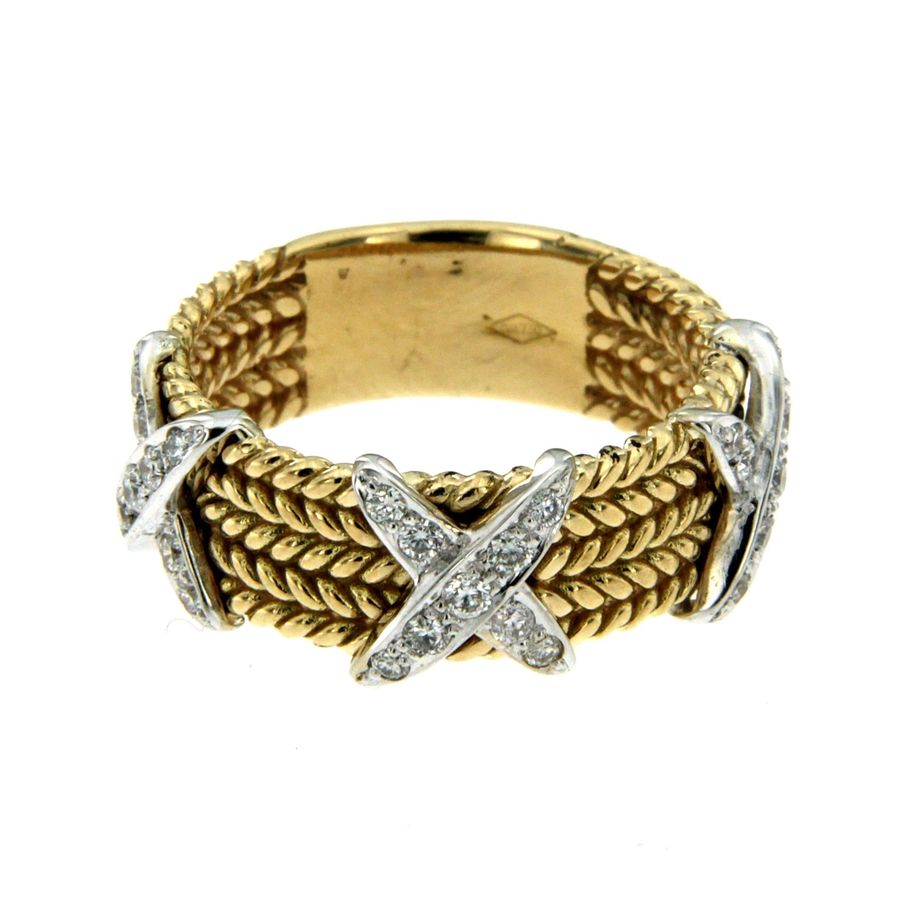 An 18 karat yellow gold ring composed of five rows of rope-twist design intersected by three X cross motifs. Each white gold cross is set with round brilliant cut diamonds weighing a total of 0.41ct, G colour and VVS clarity. 

CONDITION: Brand New