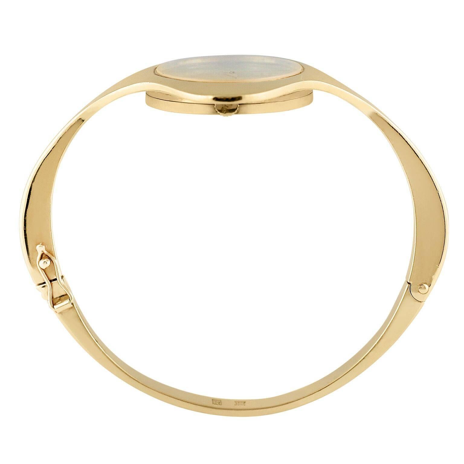 Lady's Yellow Gold Chopard bangle bracelet watch with Nephrite jade dial. Highly unique Space-Age design. Bracelet opens with hinged clasp on side. Mechanical Wind.