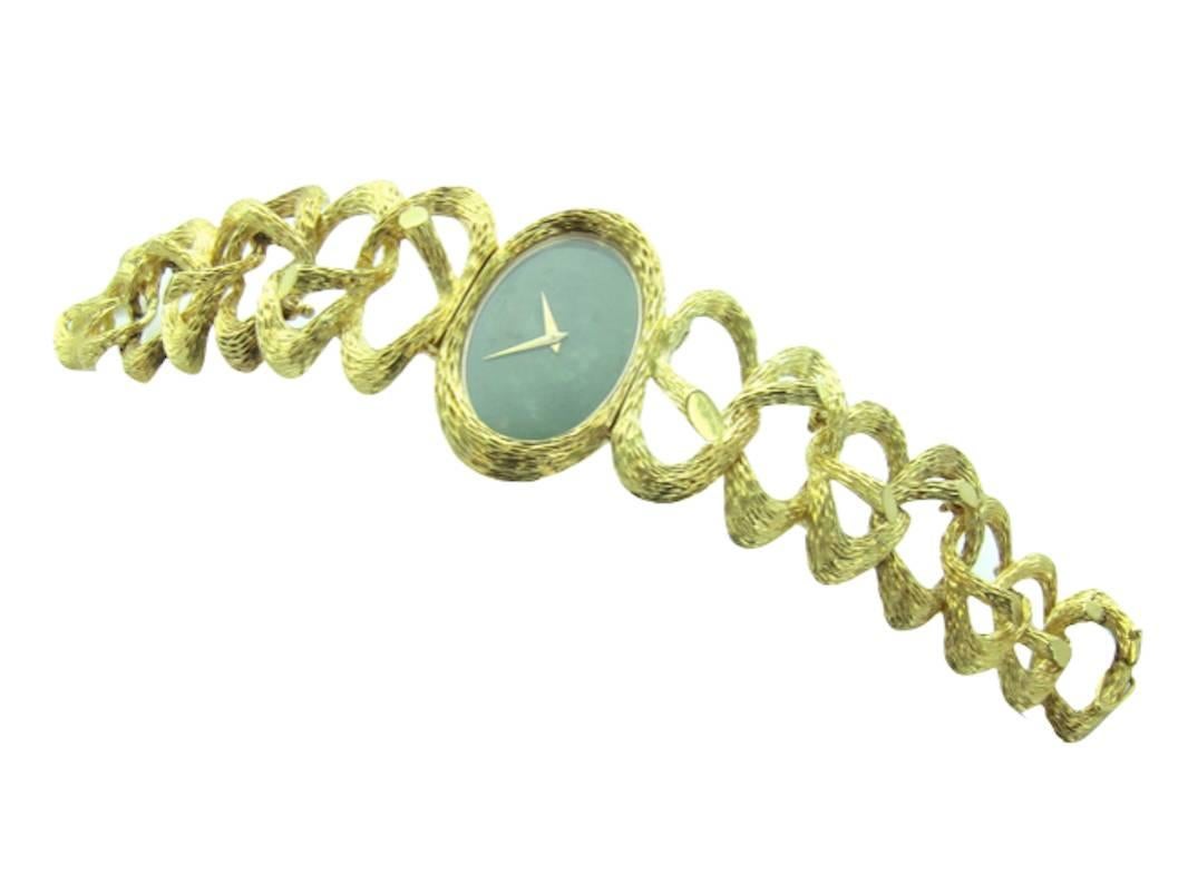 A very rare and sculptural 1970's Piaget 18k yellow gold bracelet watch with bamboo design retailed by Cartier. Nephrite dial marked Cartier. Beautiful textured bracelet with integrated bamboo forms. 

Manual Winding Movement.

