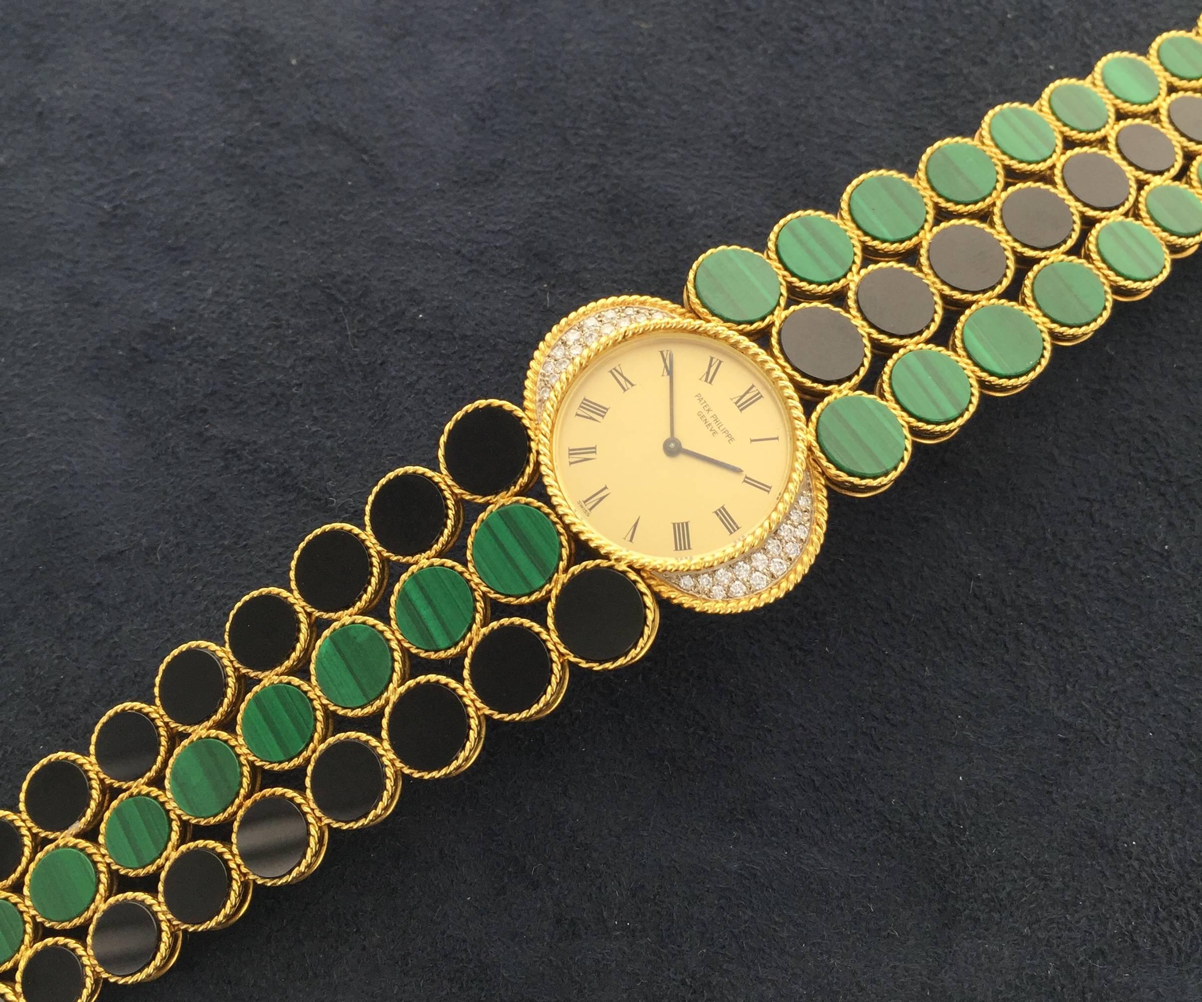 Manufactured in 1976, this rare Patek Philippe is an amazingly stylish and decorative jewelry watch. 18k yellow gold with integrated three strand bracelet with black onyx and malachite-set links. Diamond-set bezel with rope-twist