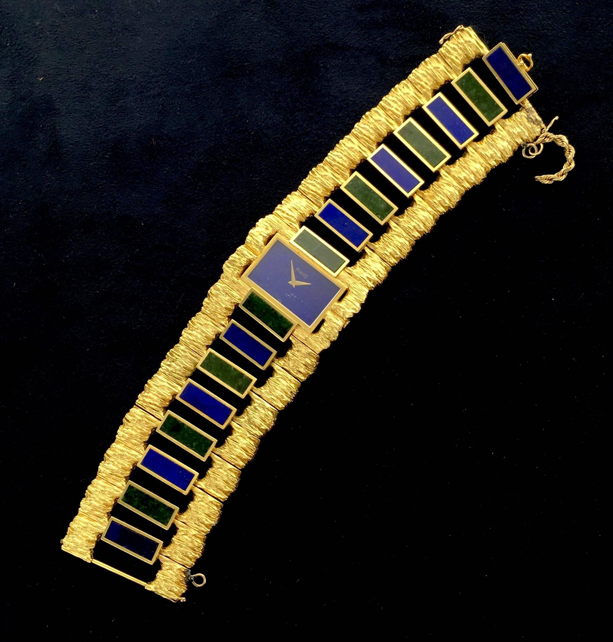 An early 1970's Piaget 18k yellow gold wide bracelet watch with lapis and nephrite jade rectangular inlayed links. The hand-finished nuggety-textured gold work is characteristic of classic 1970's Piaget, a time in which Piaget produced extraordinary