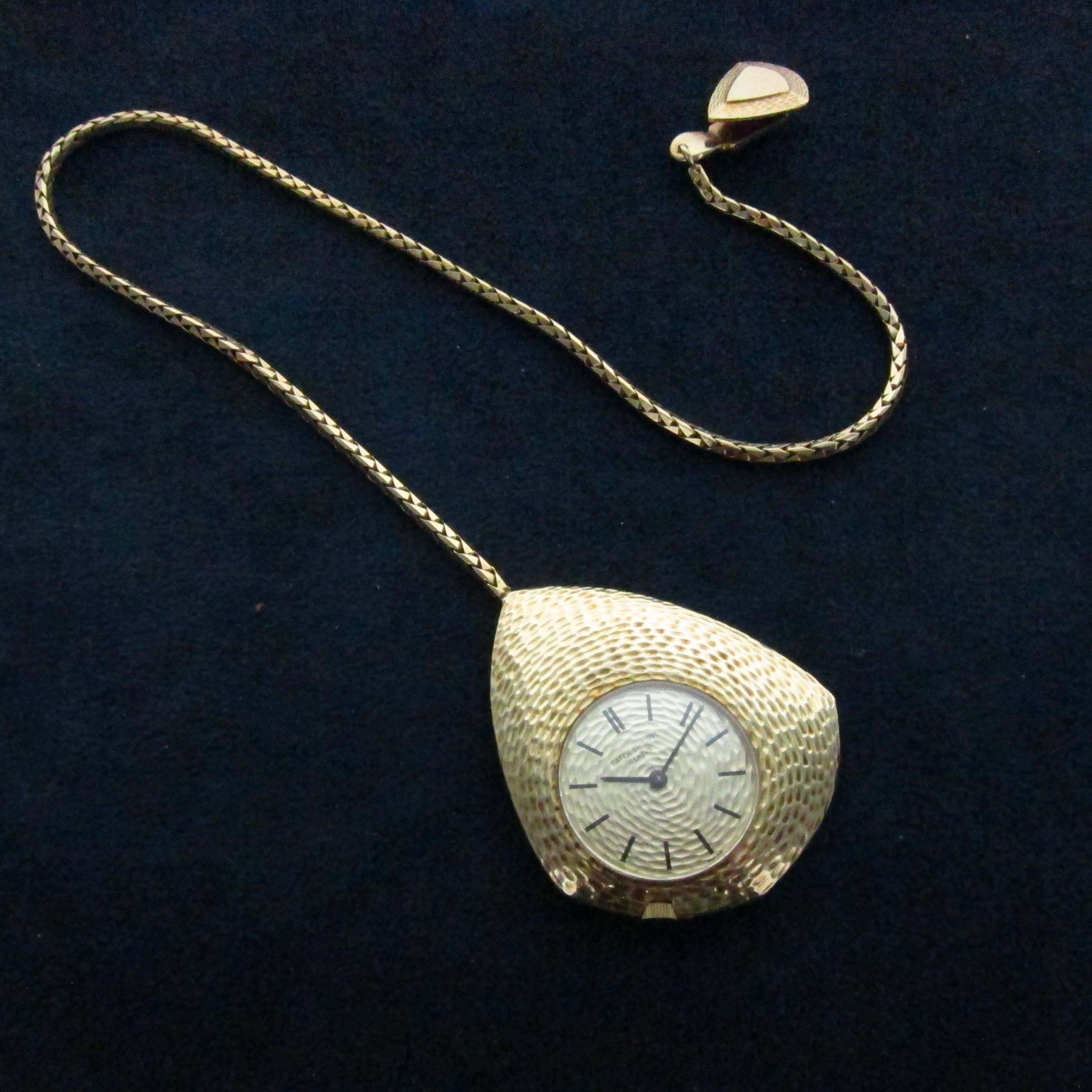 An unusual and rare Patek Philippe keyless lever pocket watch with fitted chain in 18k yellow gold. Hammered-finish textured case. 18 jewel calibre 23-300 mechanical movement. 18k Gold Patek Philippe link watch chain and fob, case, dial and movement