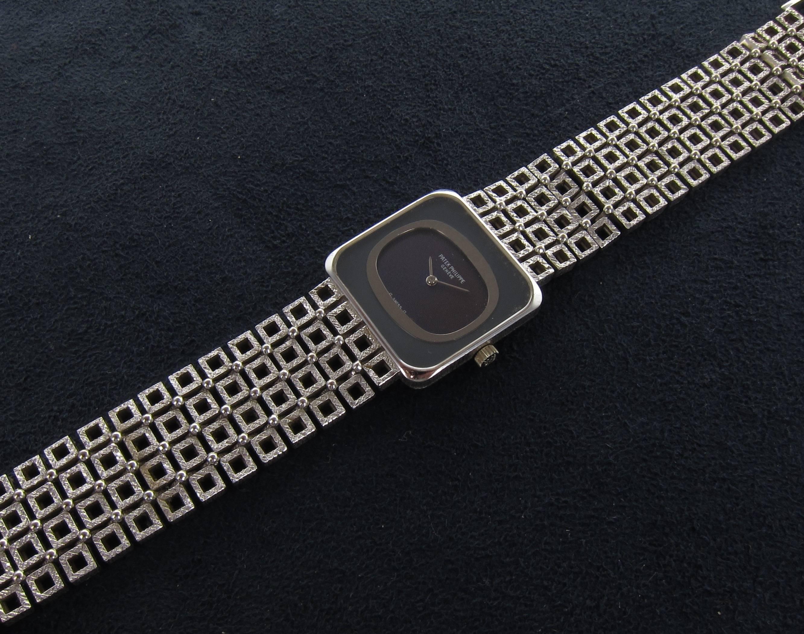 A late 1970's Patek Philippe 18k white gold bracelet watch with hand-finished textured bracelet composed off small squares. Dark blue dial signed 