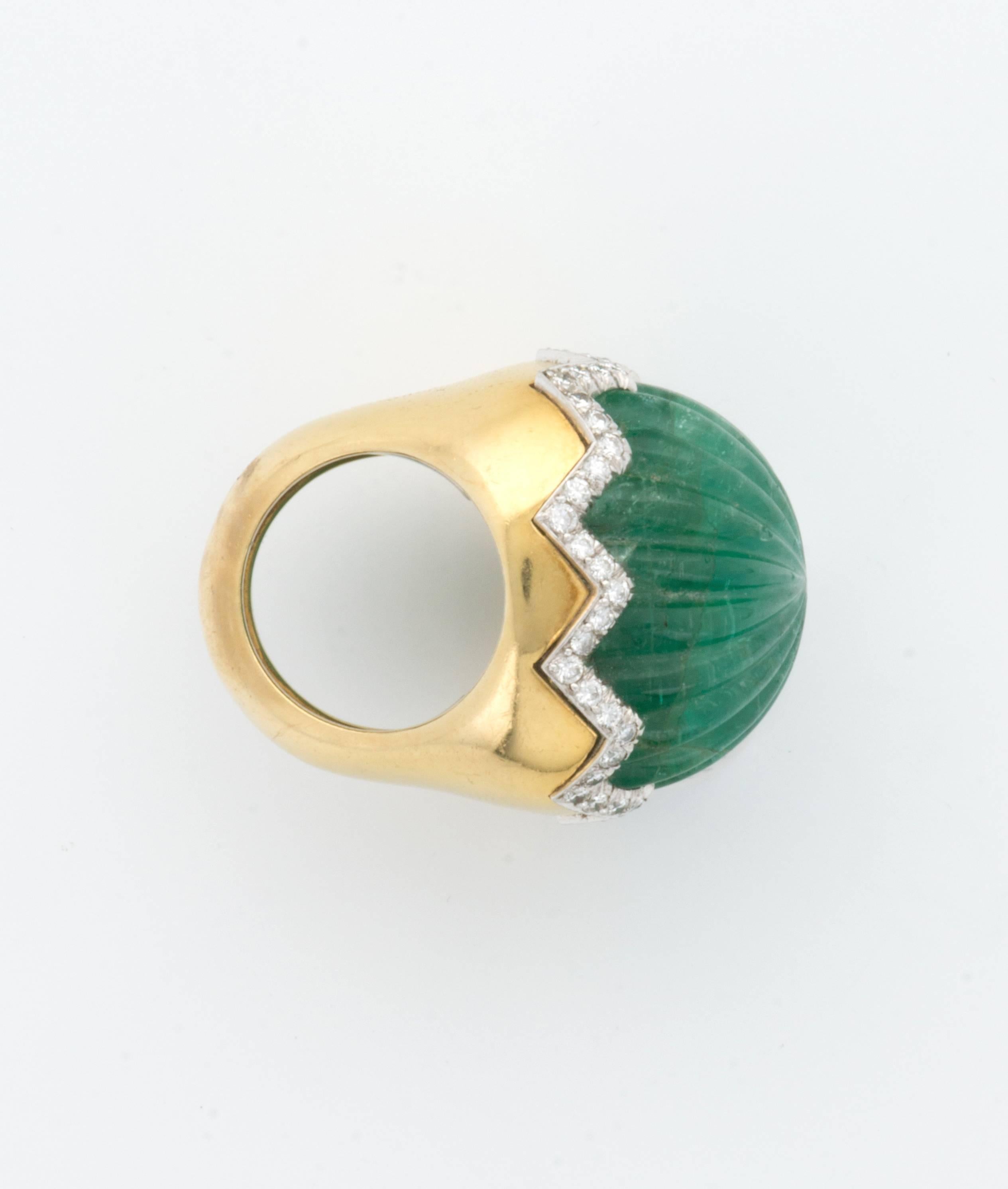 A highly unusual carved Emerald dome ring with zig-zag diamonds in 18k yellow gold by David Webb. 

Approximate 40 carat emerald.

1960's