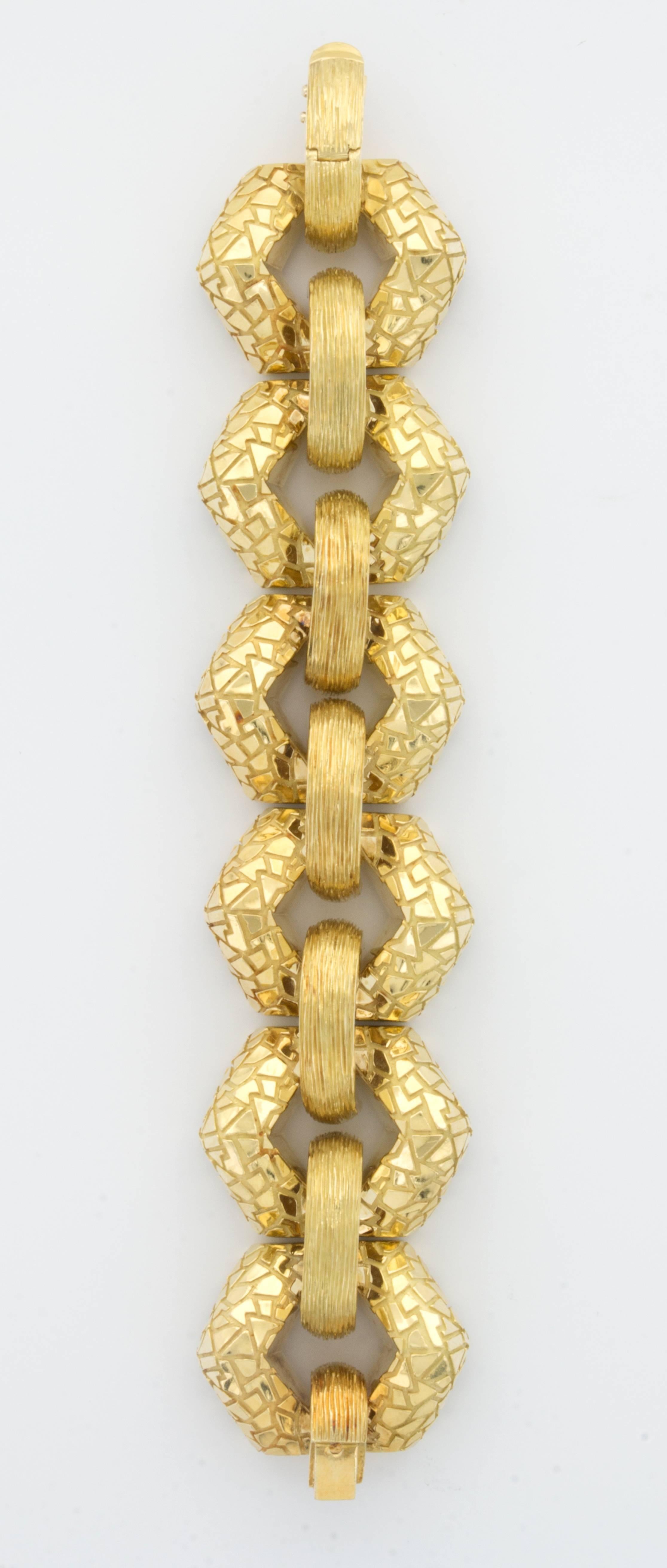 A large textured chain-link bracelet in 18k yellow gold by designer Henry Dunay. Very wide, substantial and stylish. 

159 grams.

1990's

