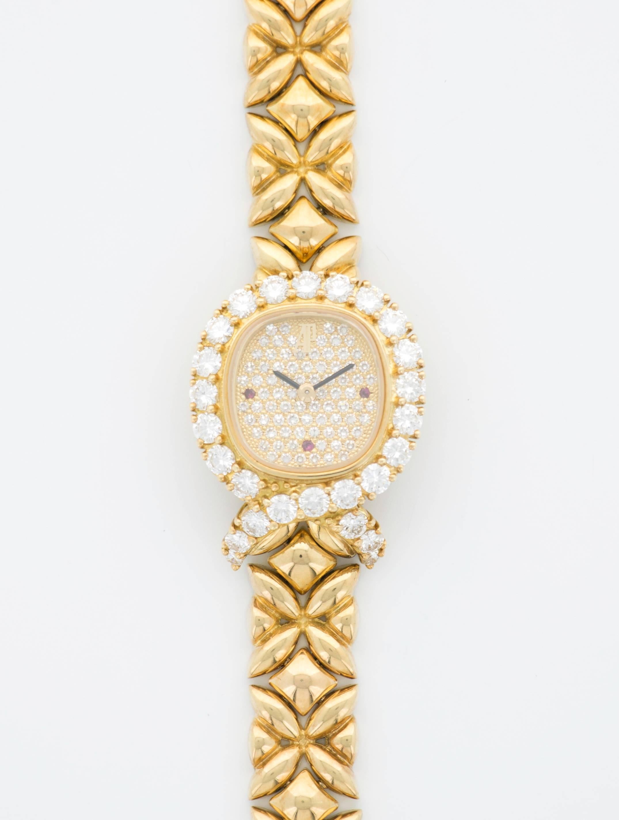A lady's Audemars Piguet 18k Yellow Gold Bracelet Watch with Pave Diamond Dial and Ruby hour markers. Originally purchased for $53,300 in the 1980's. An absolutely beautiful, classic Audemars Piguet lady's watch.

