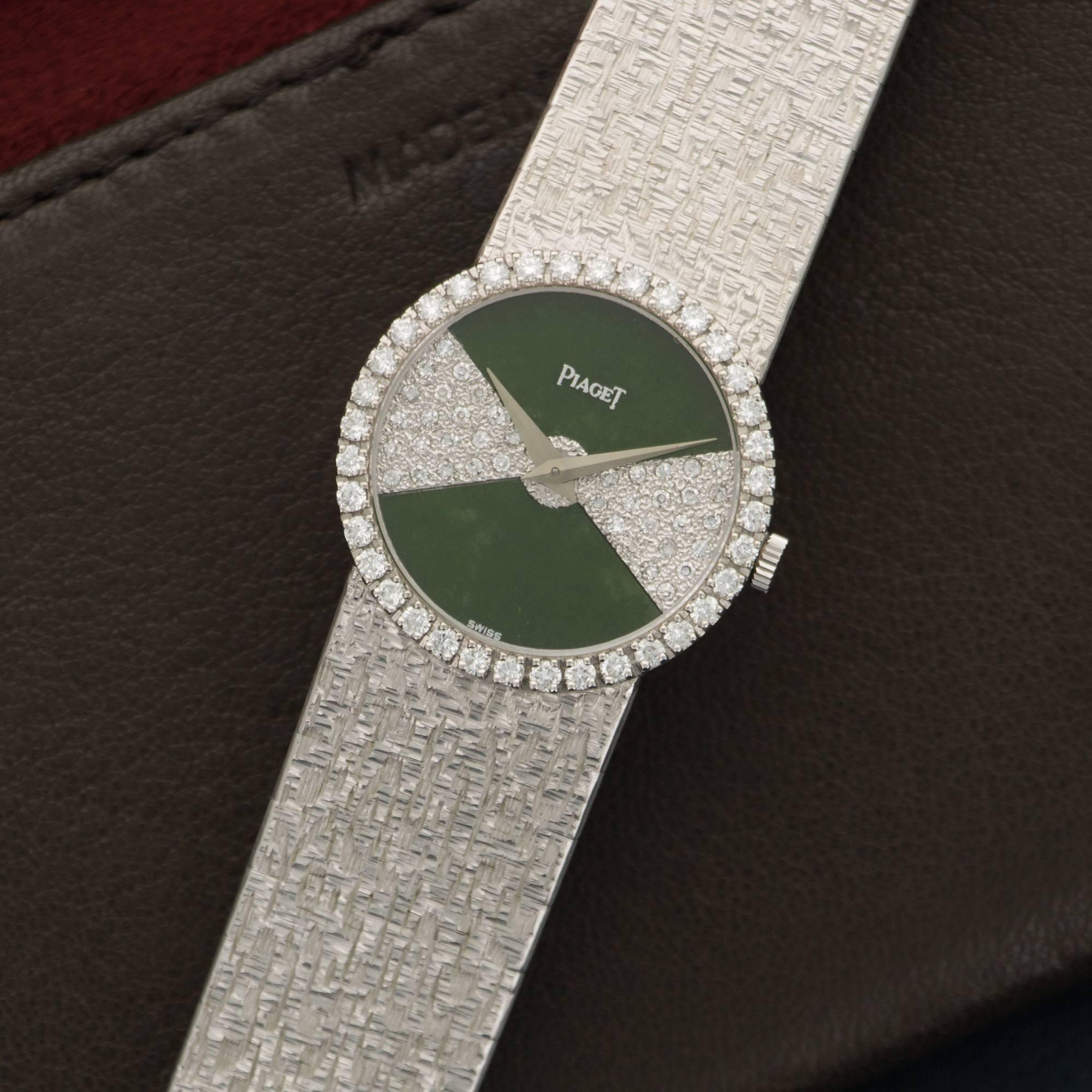 An 18k white gold pave diamond and nephrite jade bracelet watch, by Piaget. Model number 9706. Mechanical winding. 25mm case size. Circa 1970's.
