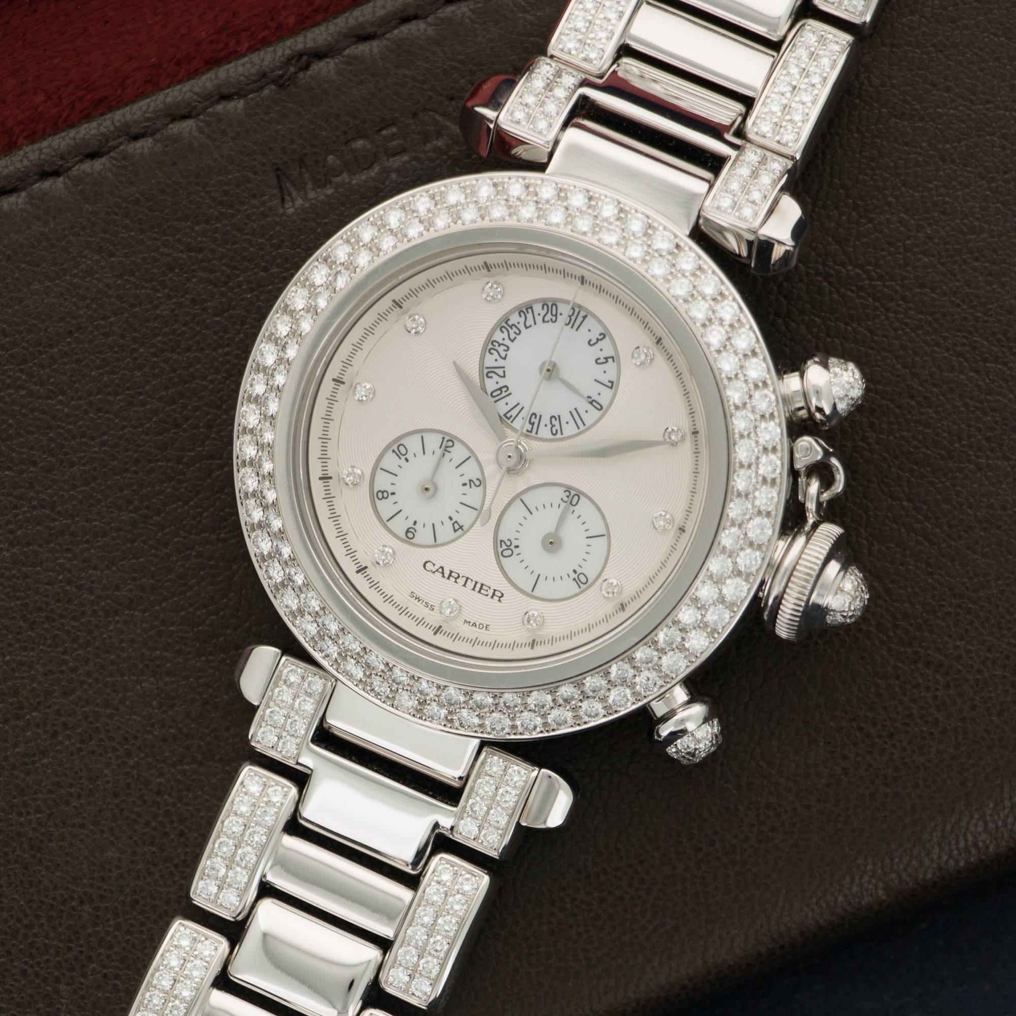 An 18k White Gold Pasha Chronograph Watch by Cartier. Full Diamond Bracelet. Silvered dial with Diamond Markers and Mother of Pearl Sundials. Model Number 1357. Case Diameter 35mm. 