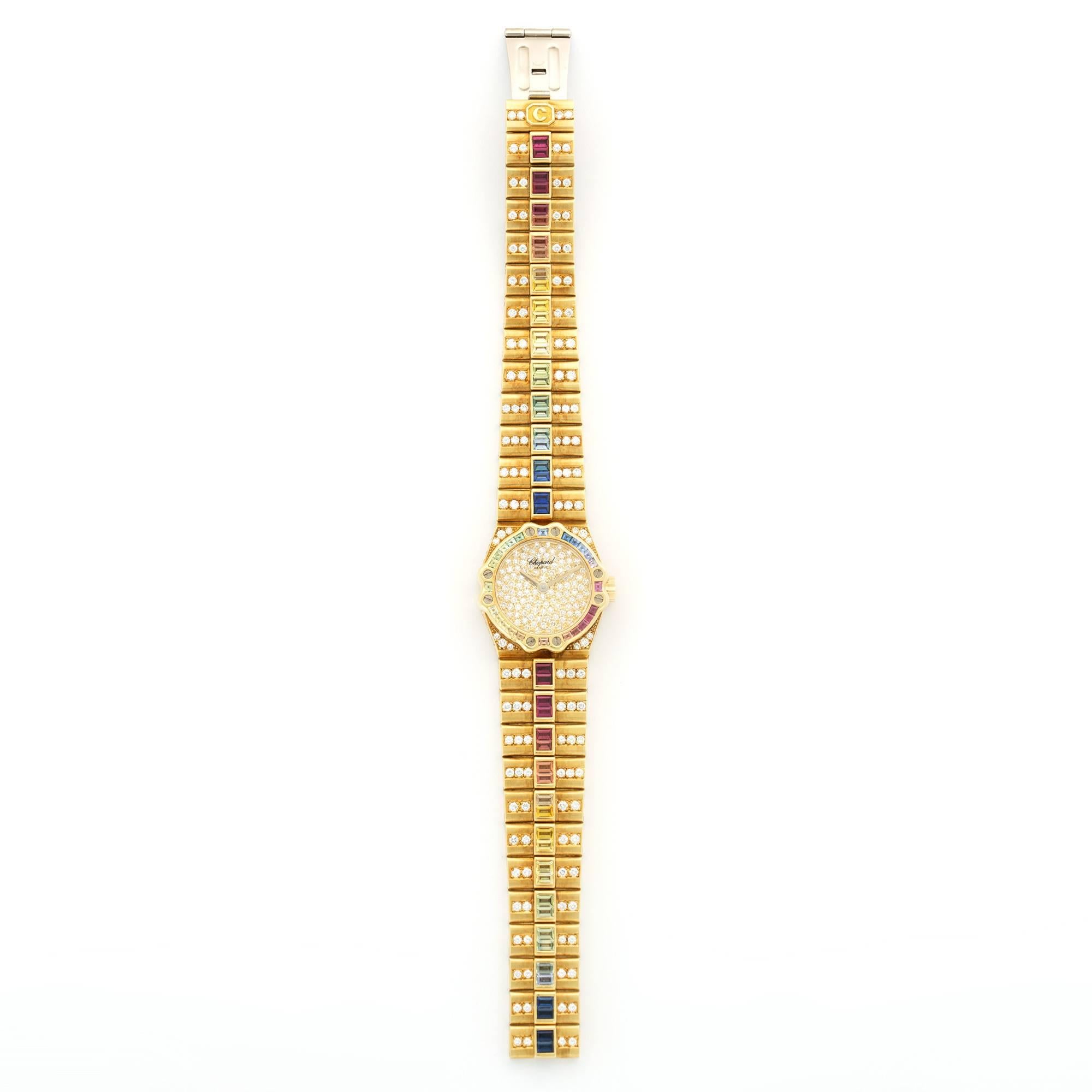 An 18k Yellow Gold St. Moritz Wristwatch by Chopard. All Original Pave Diamonds with Multi-Color Rainbow Sapphires. Circa 1990's. 24.5mm Case Diameter. 