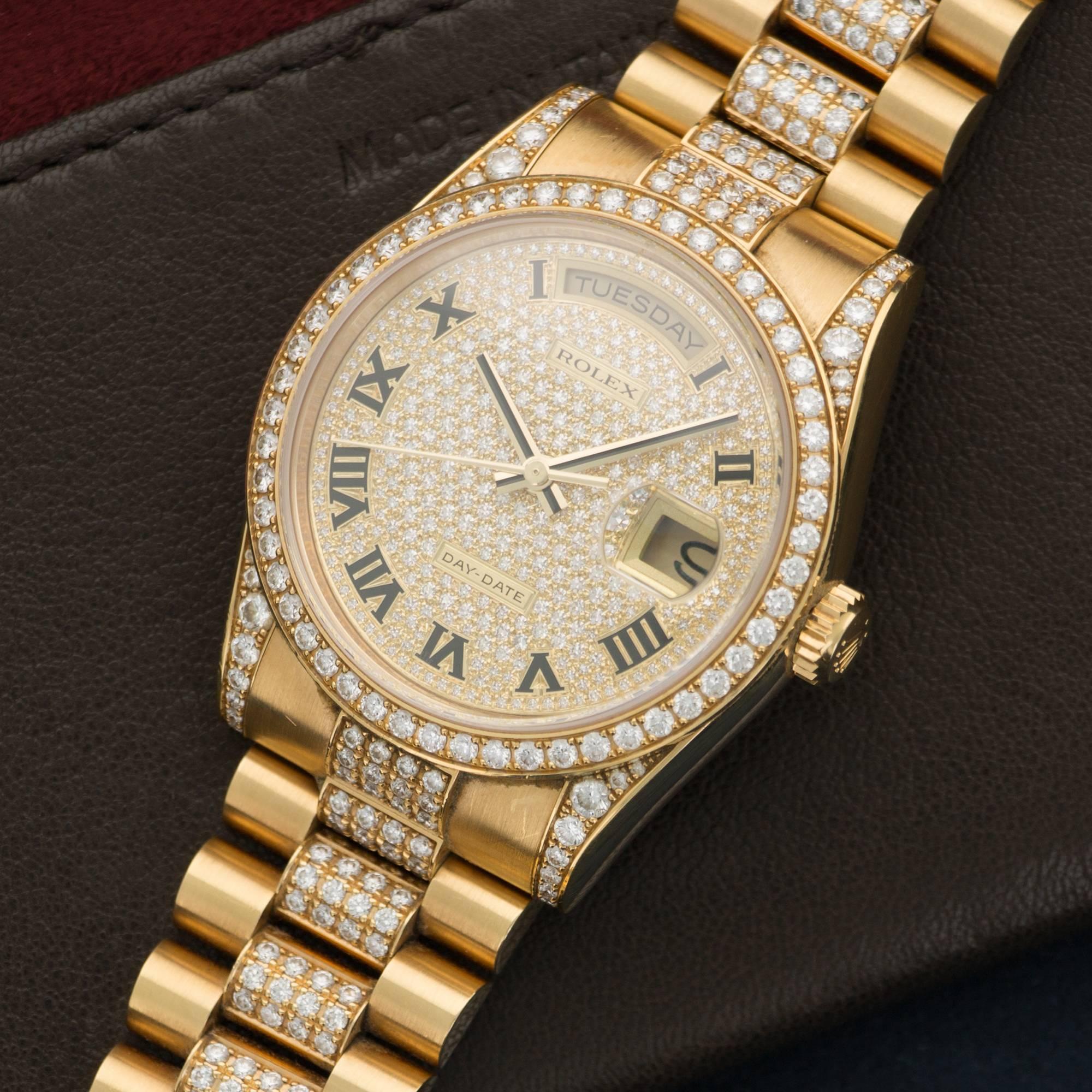 An 18k Yellow Gold Day-Date Rolex with Full Pave Diamond Dial, Diamond Bezel, Diamond Lugs, and Diamond Bracelet. All 
Original Setting. 36mm Case Diameter. Like New Condition in the Original Box. Sold Originally for over $115,000