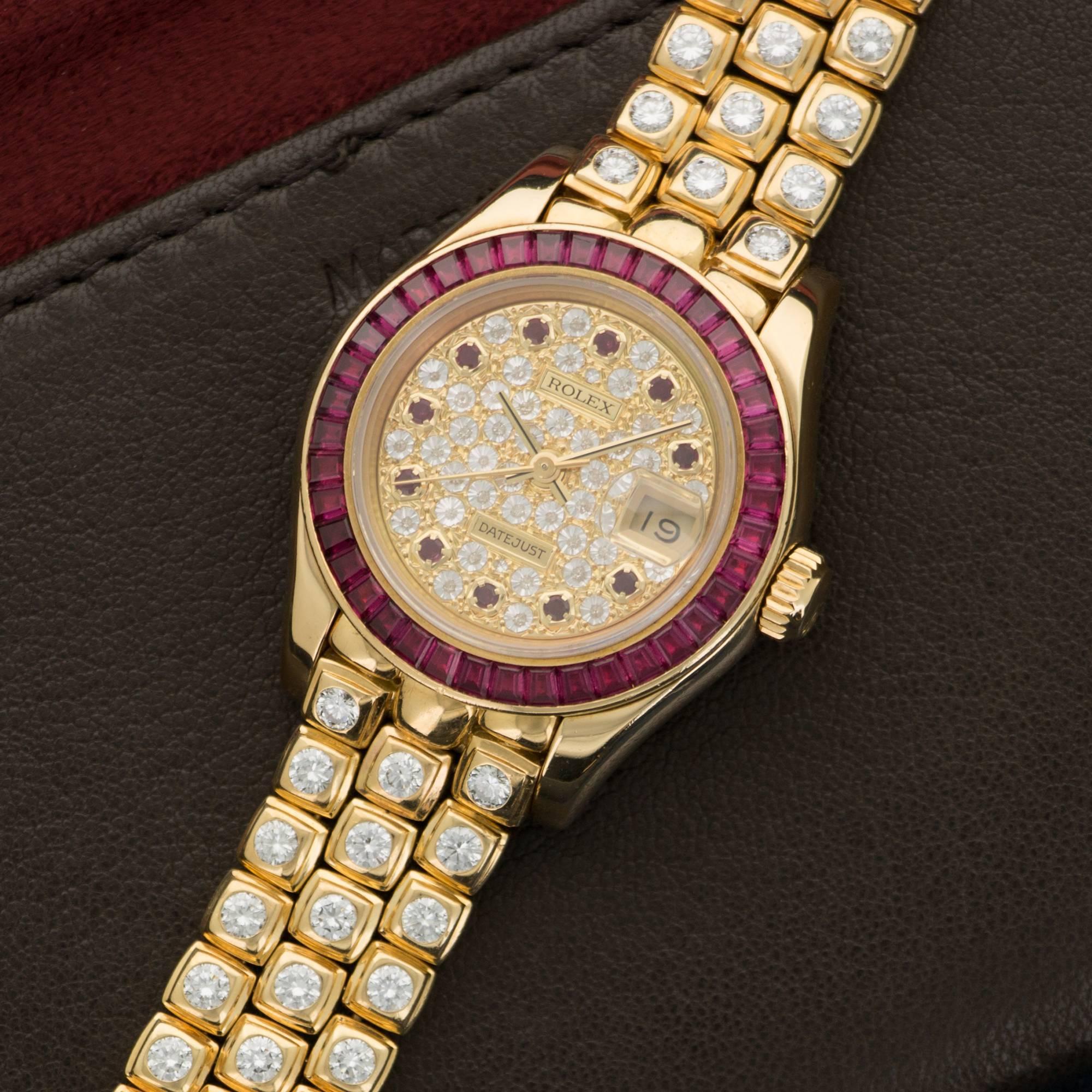 An Original and Stunning Rolex "Pearlmaster" in 18k Yellow Gold with Original Diamond Bracelet and Pave Dial with Square-Cut Ruby Bezel. Model Number 69308. 29mm Diameter. Circa 1990's Automatic Movement. All Original in Perfect Condition. 