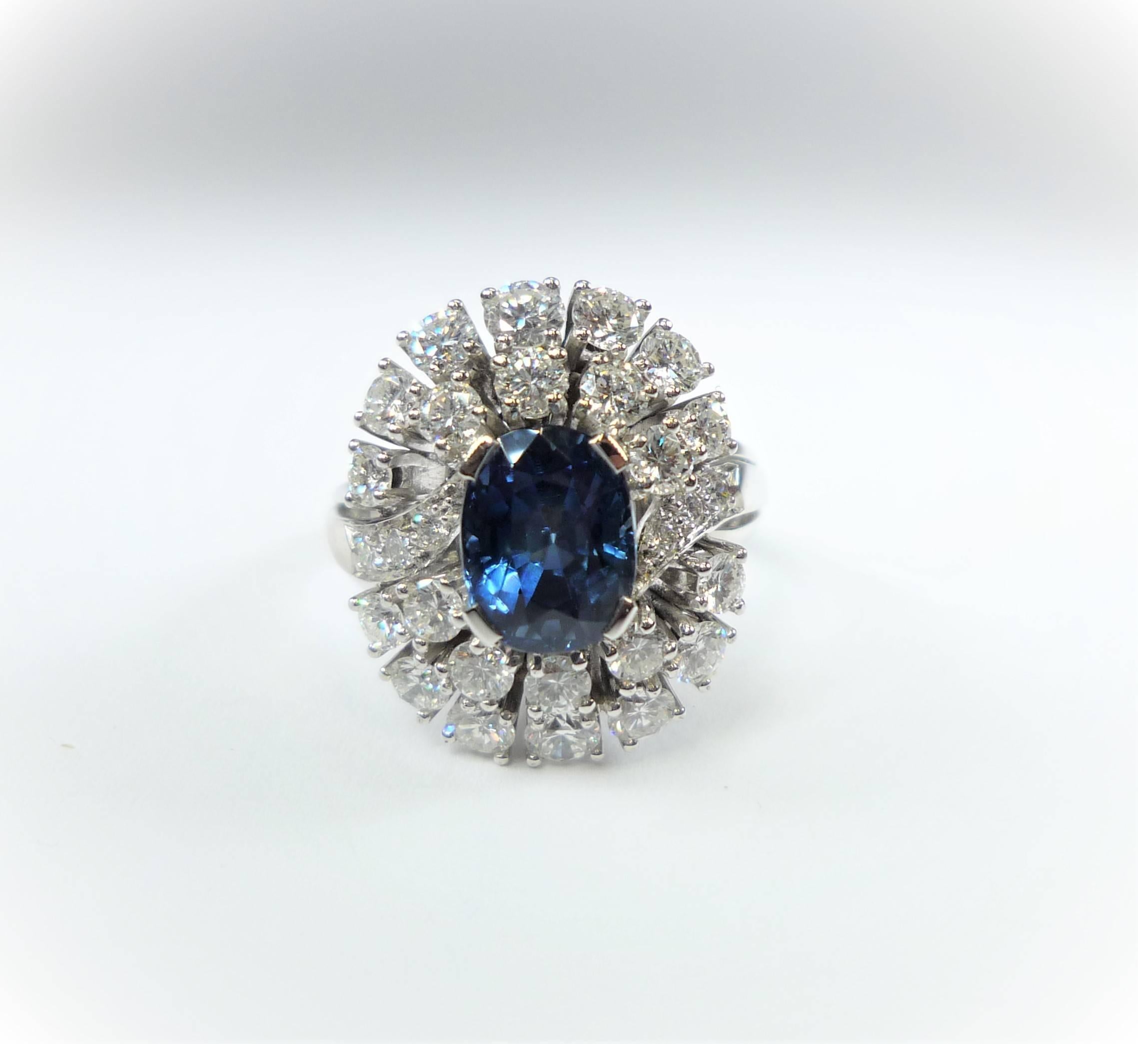 Classic style 18 Karat White Gold Ring, featuring an oval blue sapphire, 
surrounded by 28 round brilliant cut diamonds,
Sapphire: 3.1 ct. , Diamonds: 1.96 ct., Color: TW, Clarity: VS
Ringsize: 6-



   