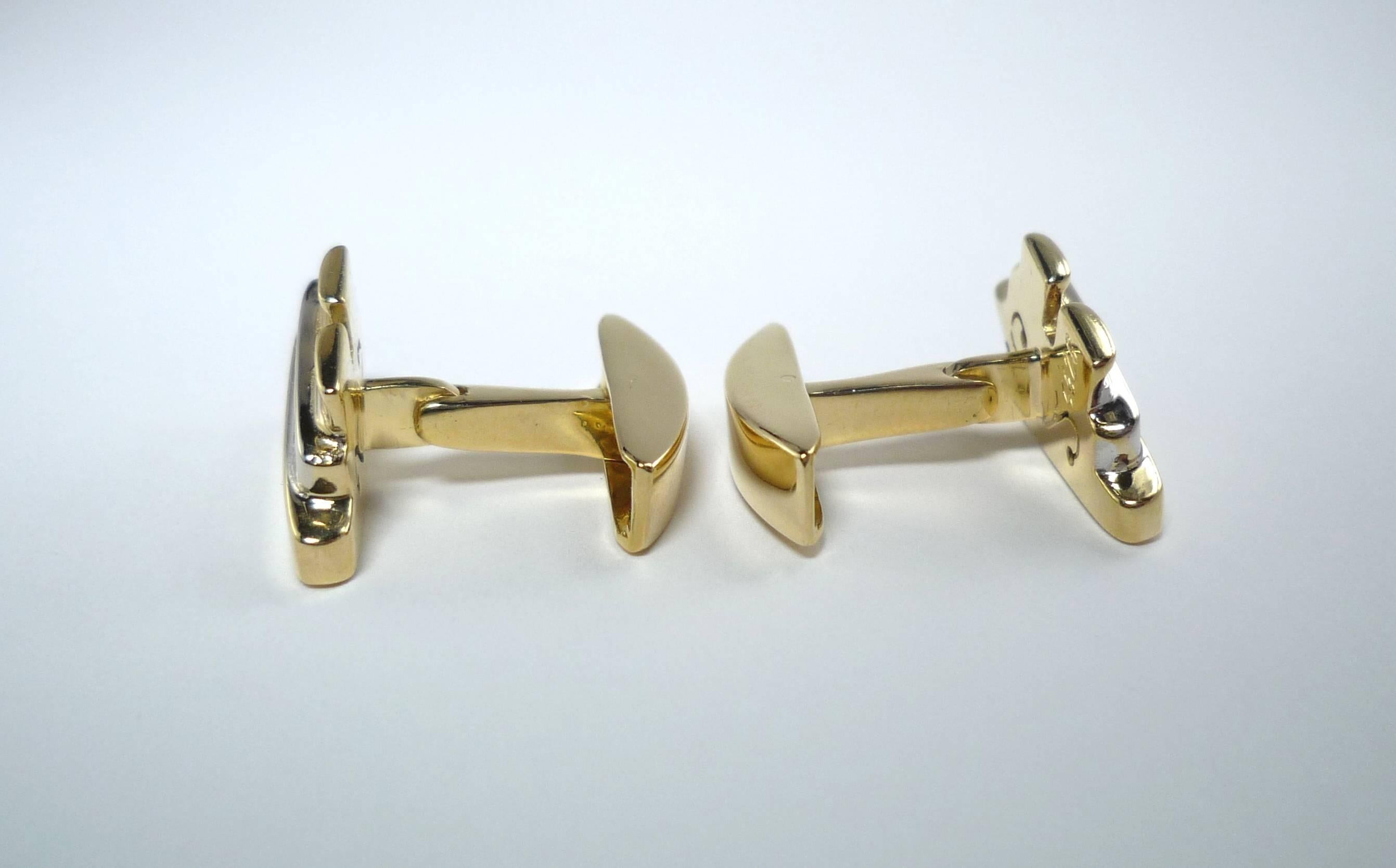 A Pair of Cufflinks in the design of a Cruise Ship with movable hinges.
The 6 Diamonds mounted in 750/-Yellow Gold and
750/-White Gold. The back can be folded down. 
Signed WEMPE