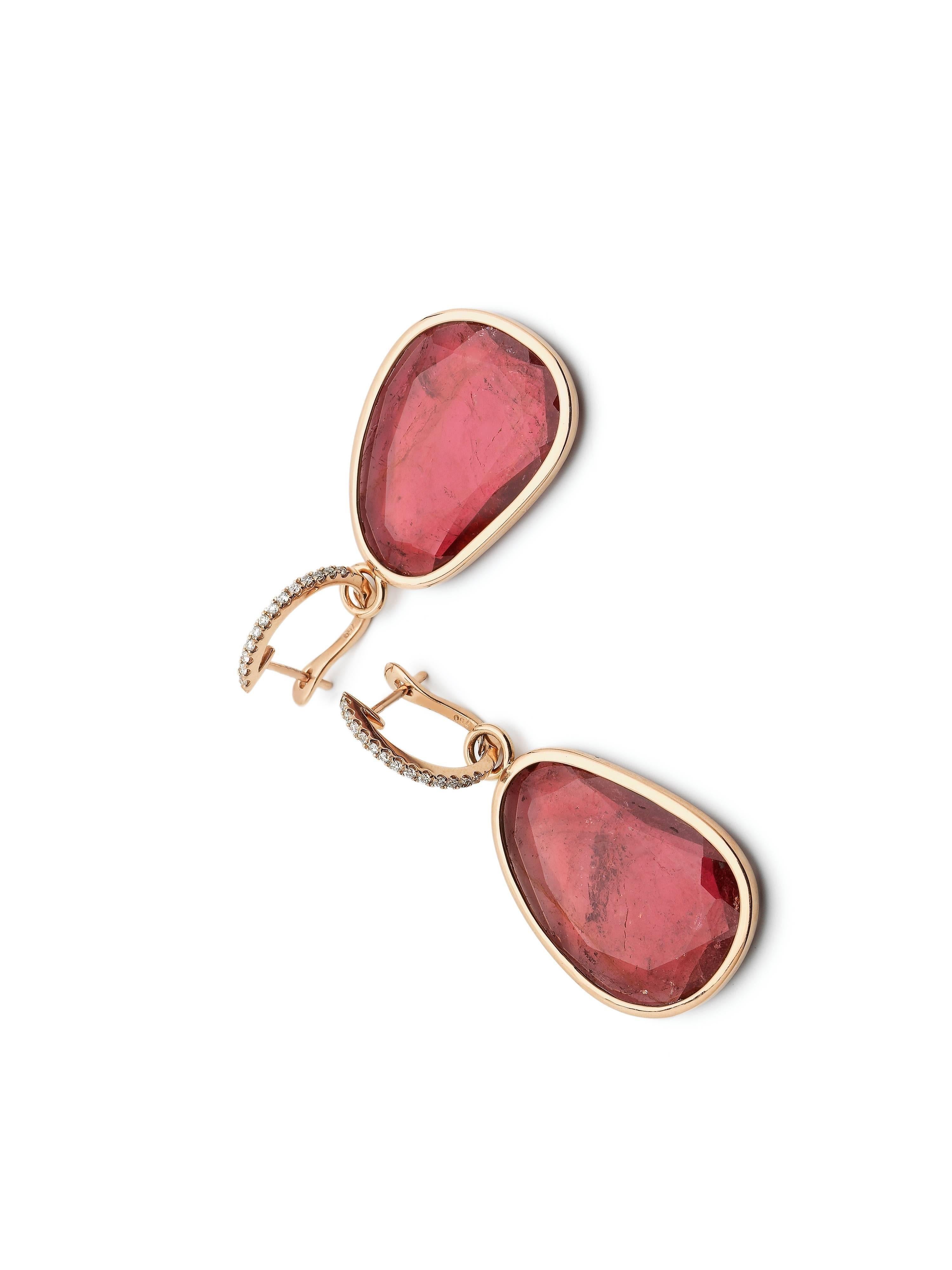 Deep pink flat tourmalines set in 18K rose gold and attached to a latch back which is set with diamonds. The weight of the tourmaline is 29.64ct and the total weight of the diamonds is 0.156ct. The size of the stone including the rim is 19.5mm x