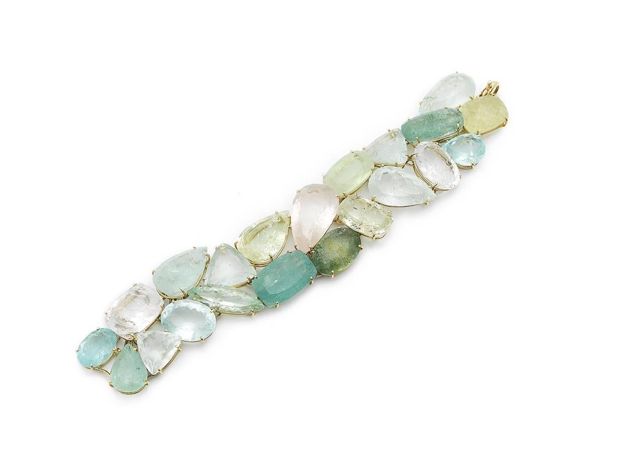 Bracelet made out of 18K yellow gold set with beryls, The 21 pieces beryl mix contains aquamarine, morganite and green beryl. The length of this bracelet is 18.5cm or 7,28-inch and the width is 3cm or 1,18-inch.