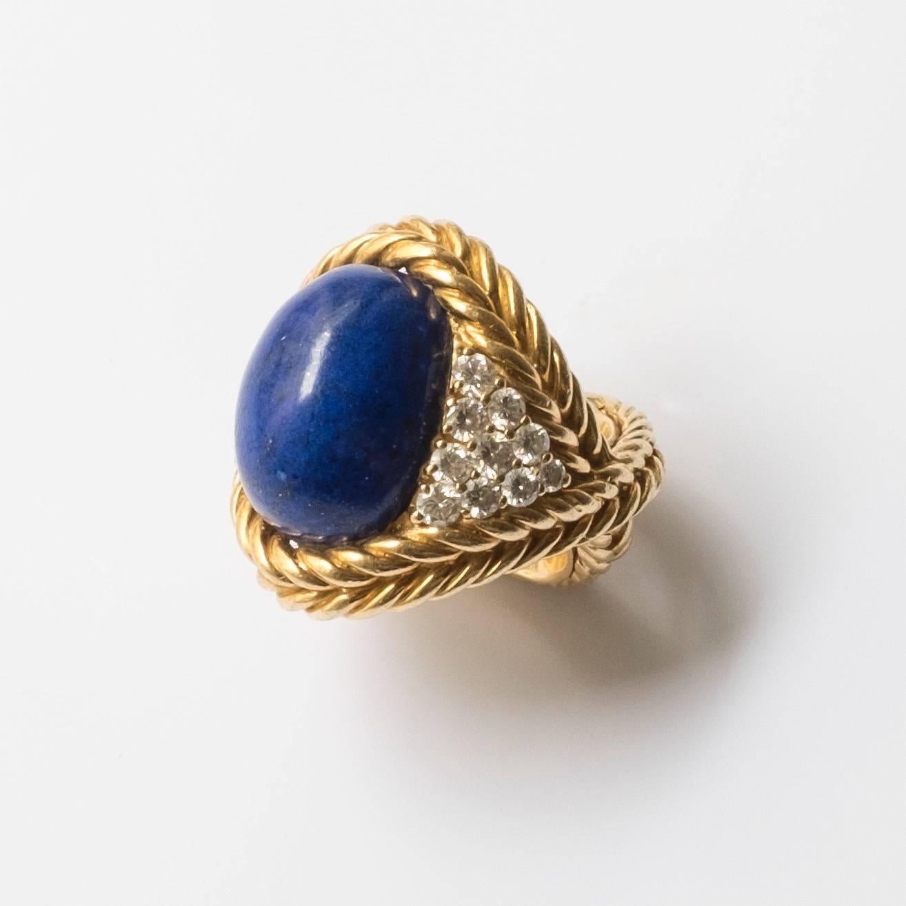 Magnificent ring by Boucheron composed of 18k gold, diamonds and lapis lazuli. The diamonds are geometrically arranged into a triangular form which are established on both sides of the centered lapis lazuli gem. The lapis lazuli and diamonds are