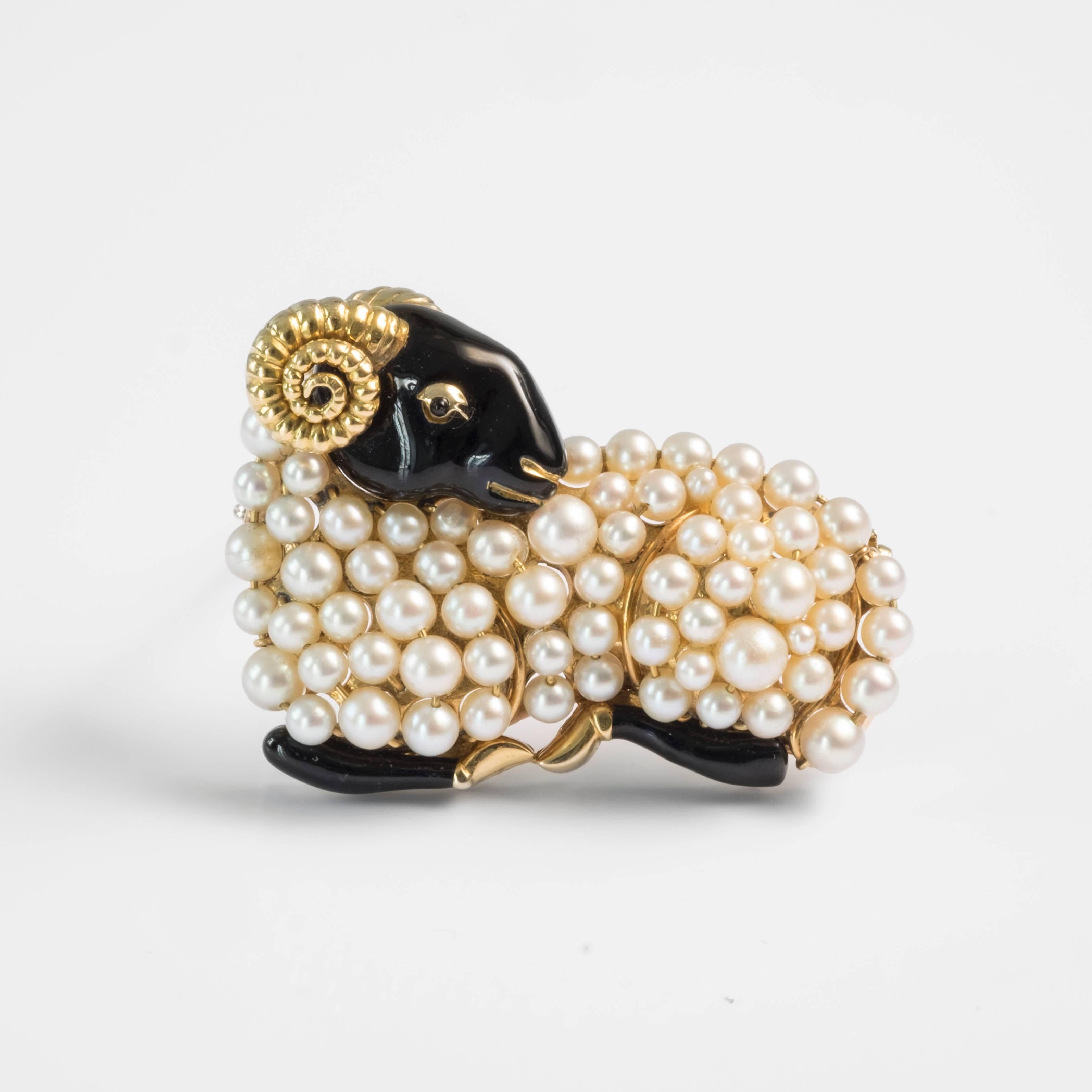 This 18k yellow gold brooch, designed by the prized French jeweler René Boivin, features a ram lying with his head on his shoulder. The ram’s head and legs are covered in black enamel, while it’s horn and feet are plated in gold. The body of the
