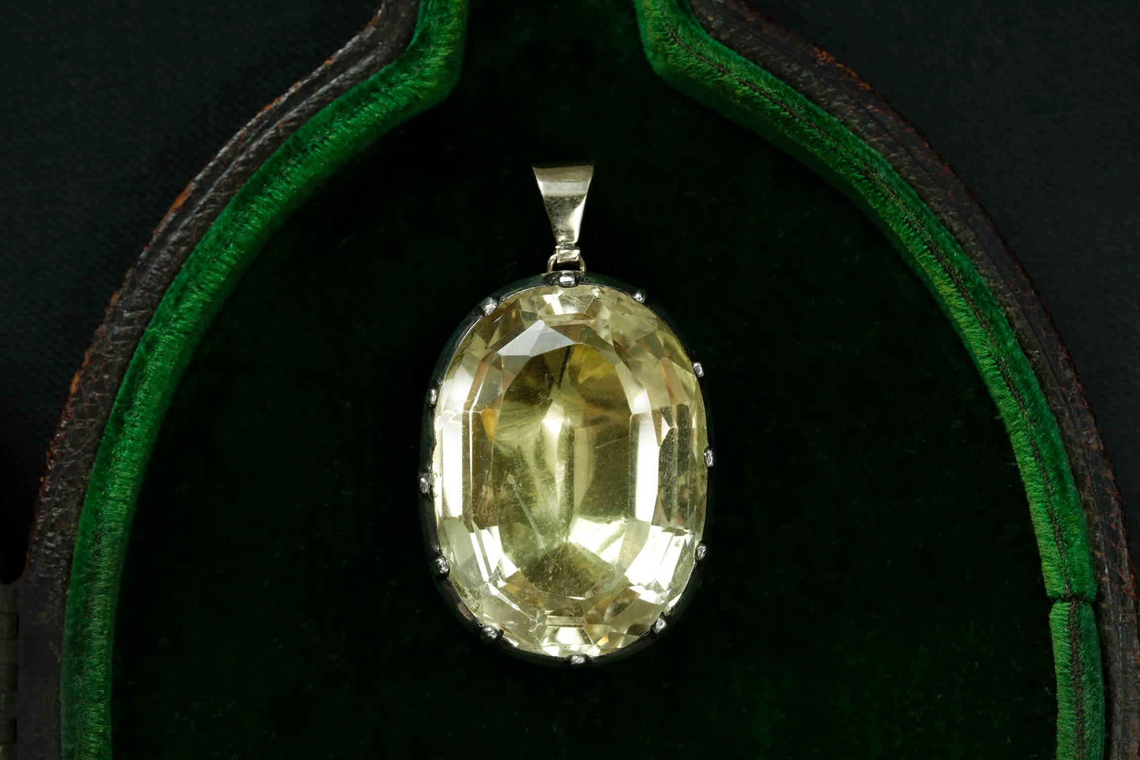 A chunky and large Georgian foiled back citrine blob pendant. A beautifully foiled citrine has the bright golden/champagne hue. The citrine is set in sterling silver, and the bale is 15k yellow gold. There is no water damage, and the pendant is in