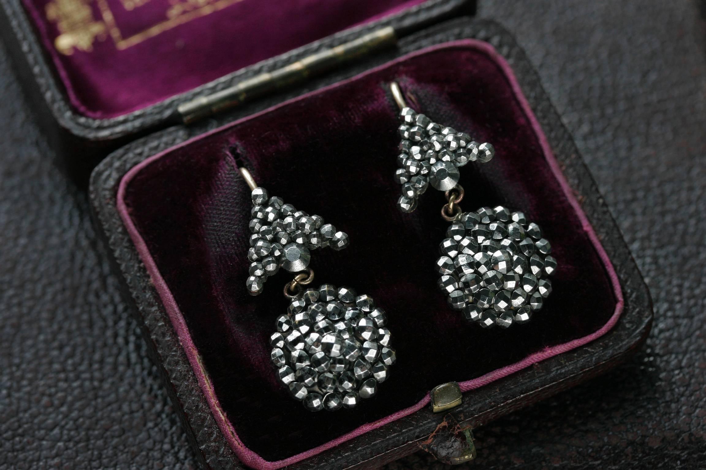 C.1830. An unique and versatile pair of Georgian cut steel earrings. The earrings have an arrow-shaped top and hanging circular bottom, which delightfully dangle and sway when worn. The size and scale of this pair makes the earrings perfect for both