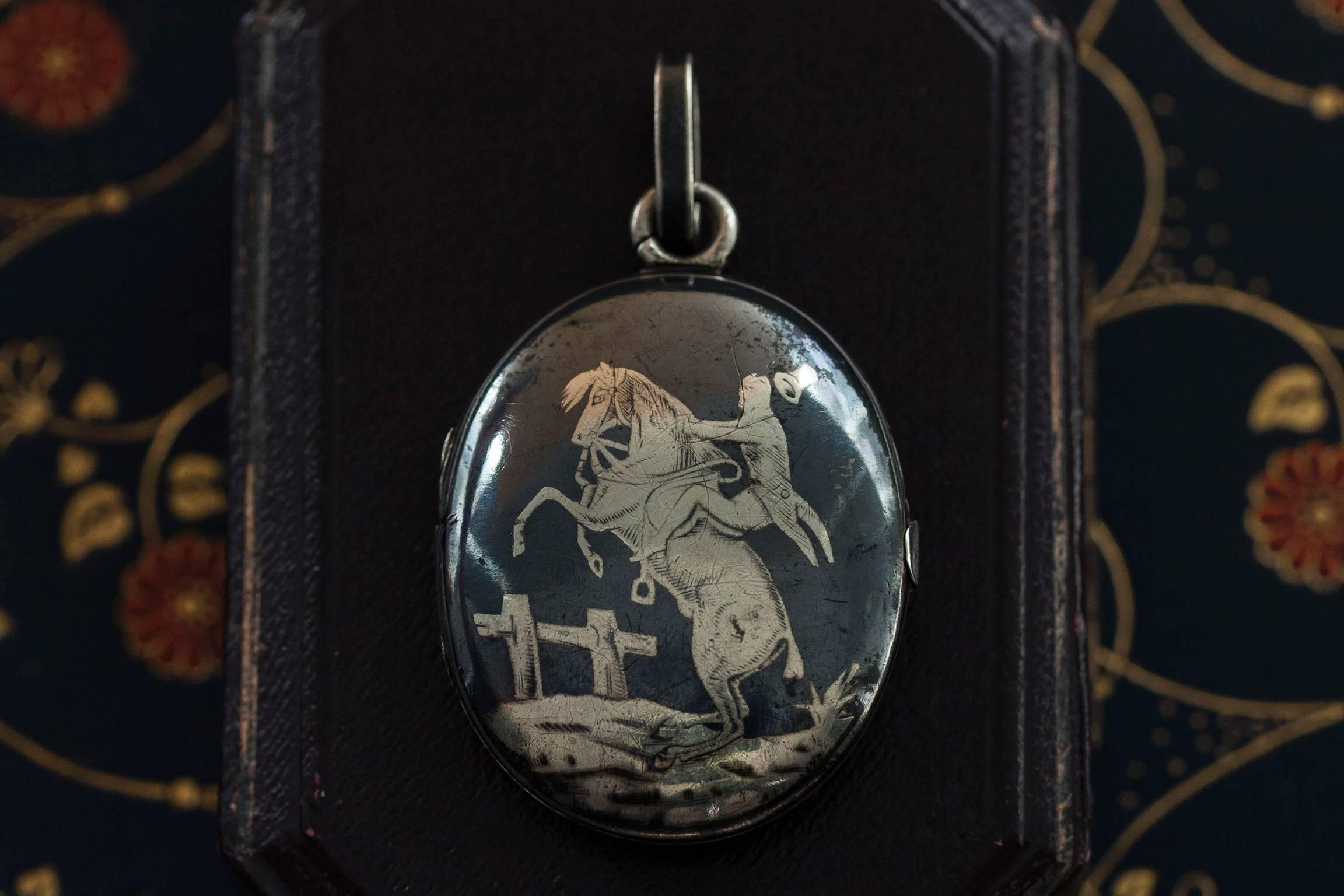 Late Victorian large sterling silver and Niello locket, circa 1890. Niello pieces were created by melding silver, copper and lead with sulphur, and using the combination to create an inlay or engraved/etched metal. Niello is more robust than enamel,
